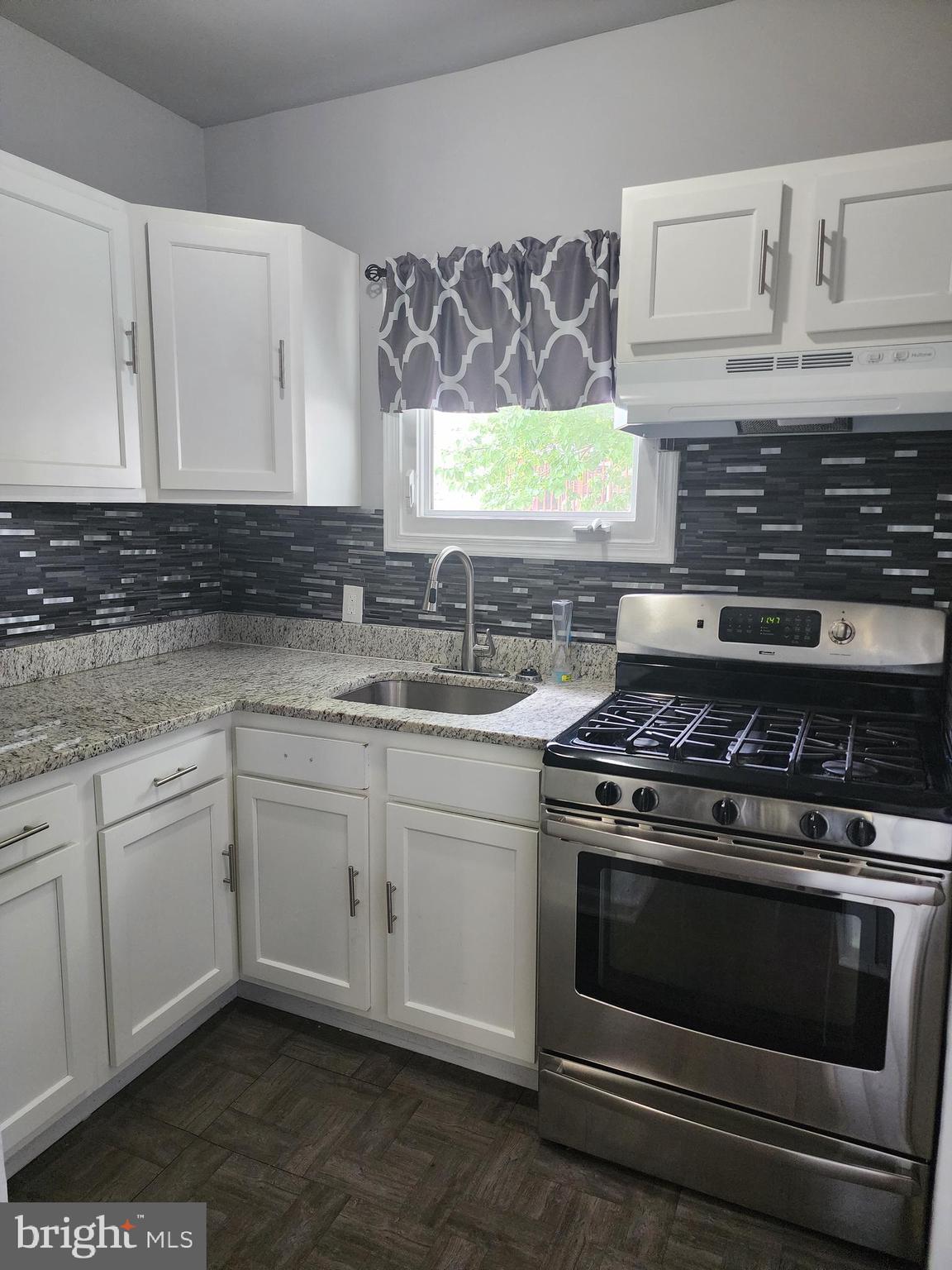 This charming colonial townhouse, is full of character and modern upgrades. Featuring 4 spacious bedrooms and 2 full bathrooms, this home offers ample space for comfortable living.  Step inside to find gleaming hardwood floors throughout, an updated kitchen with modern appliances, and built-in doors in the living room/family room that add a touch of elegance. Enjoy your morning coffee on the covered front porch and take advantage of plenty of parking.  Conveniently located with easy access to I-695 and I-95, this home is perfect for commuters. Don't miss out on this treasure that combines cosmetic charm with essential utility upgrades.
