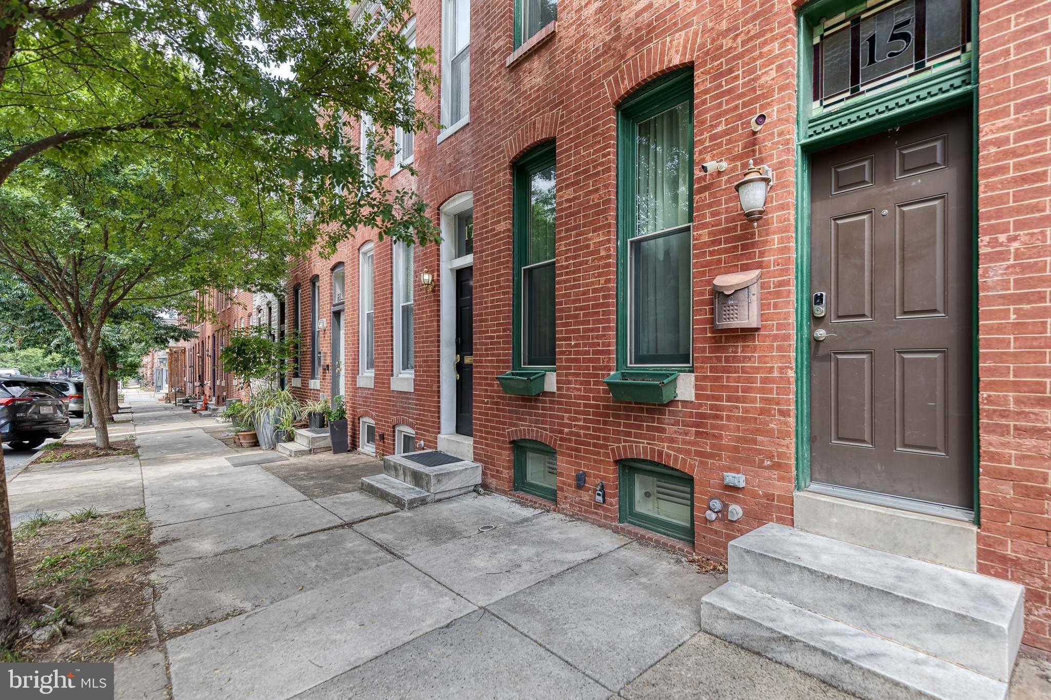 Charming brick rowhome in Patterson Place,  right off Patterson Park, featuring beautiful hardwood floors, high ceilings, exposed brick, decorative fireplaces, and timeless character throughout. 

The spacious kitchen offers ample of counter space, updated cabinetry, and access to the rear fully fenced patio. Kitchen opens up to a large dining room with plenty of room to host. Main floor also has a convenient main-level half bath.

Upstairs, you’ll find two bedrooms, two full bathrooms, and stacked laundry. The finished lower level with carpeting and recessed lighting provides additional living space, perfect for a family room, home office, or gym. 

Ideally located near Patterson Park, walking distance to Hopkins, shopping, dining, and commuter routes.