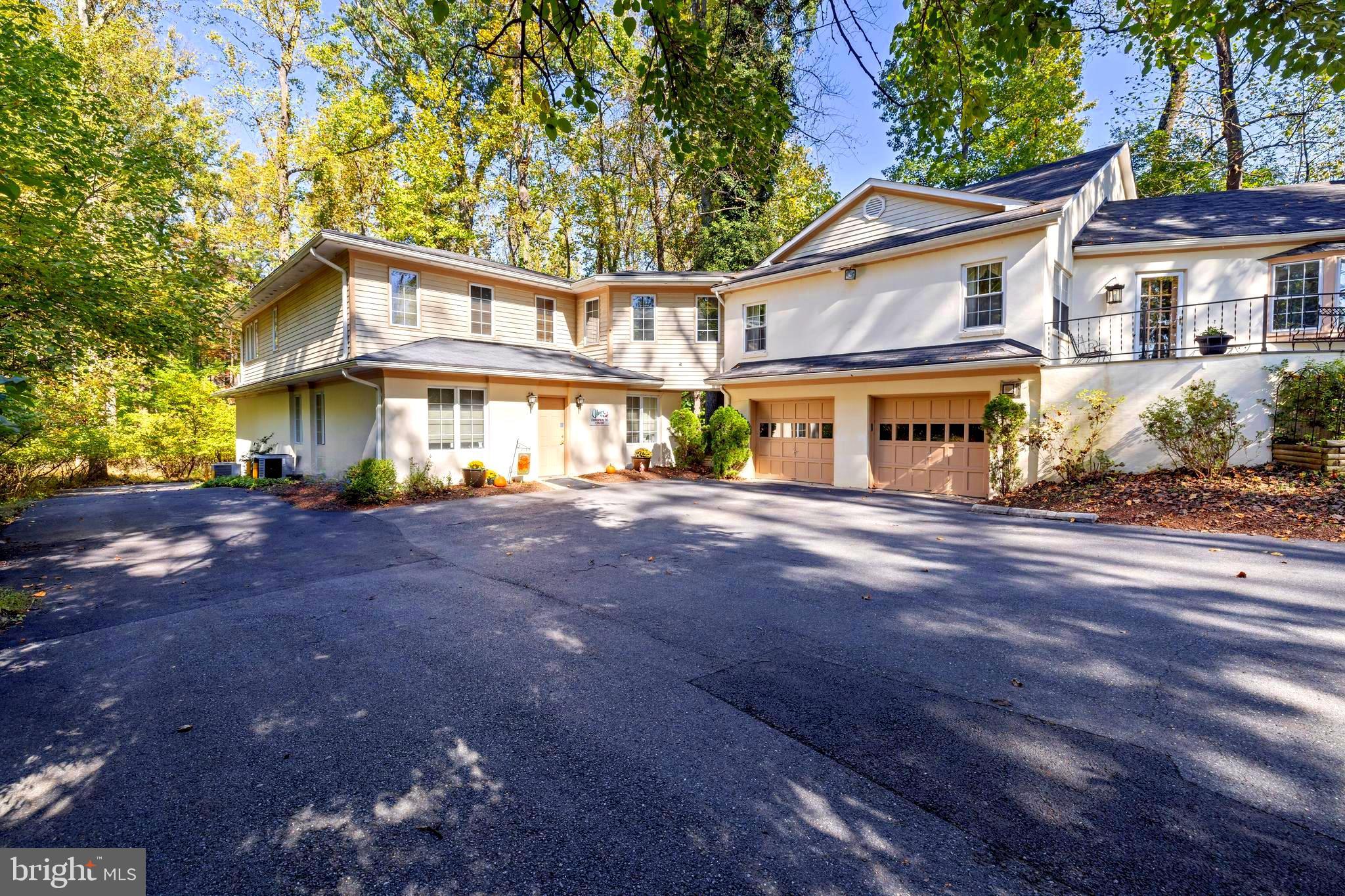 Discover a rare hybrid residential–professional property offering exceptional flexibility and long-term value. Set on a full acre along Route 108—one of Olney’s primary corridors—this unique property combines comfortable living space with a purpose-built professional office, providing visibility, functionality, and versatility seldom found in a residential setting. This property allows an owner-occupant to operate a professional business on-site, while residing in the home, with the ability to pay oneself rent rather than paying rent to a third party. The property includes approximately 3,526 square feet of finished residential living space, plus an attached professional office suite of approximately 1,710 square feet, originally constructed by the owner and successfully used for medical and healthcare practices for decades. A 1993 expansion thoughtfully integrated both components, creating a cohesive and well-designed layout. The property currently holds a transferable Use Permit for a Home Healthcare Practitioner. However, under Montgomery County Zoning Ordinance Chapter 59, a clinic with up to four medical or dental practitioners may be permitted for conditional use upon approval by the Hearing Examiner. The professional office suite space is presently configured for a Chiropractic practice and features ample parking, a large reception area, administrative office space, five private patient rooms, and a secondary administrative area, offering adaptability for a variety of medical, wellness, or other professional uses. And  although zoned residential, the property allows a wide range of uses by right.  A mother-in-law suit could also be configured in this space as it is on the ground level. The residential portion of the home is beautifully maintained and offers four spacious bedrooms, each with its own en suite bathroom, along with a living room that includes a fireplace, an exceptionally large formal dining room, a butler’s pantry/bar area, and a spacious kitchen open to a breakfast area and family room. Recessed lighting enhances the living spaces, while sliding glass doors lead to a private, fenced rear patio and a generous backyard—ideal for outdoor entertaining and relaxation. One upstairs bedroom—ideal as a primary suite—features a cathedral ceiling, while the primary suite on the main level includes a separate private office with serene views of the surrounding woods. A two-car garage with interior access adds everyday convenience. This property is ideal for operating a professional practice on-site, living and working in one location, or leasing the residential and office components separately and presents a compelling opportunity to build equity in owned real estate.  Although this property sits on a quiet wooded lot in central Olney, within just a couple of minutes is Montgomery Medstar Hospital, the Olney Theater, Good Council High School and a variety of Strip malls and Shopping centers, Restaurants and Cafes (ranging from casual to sit-down favorites), as well as other Services and Offices, all offering much sought after unique amenities.