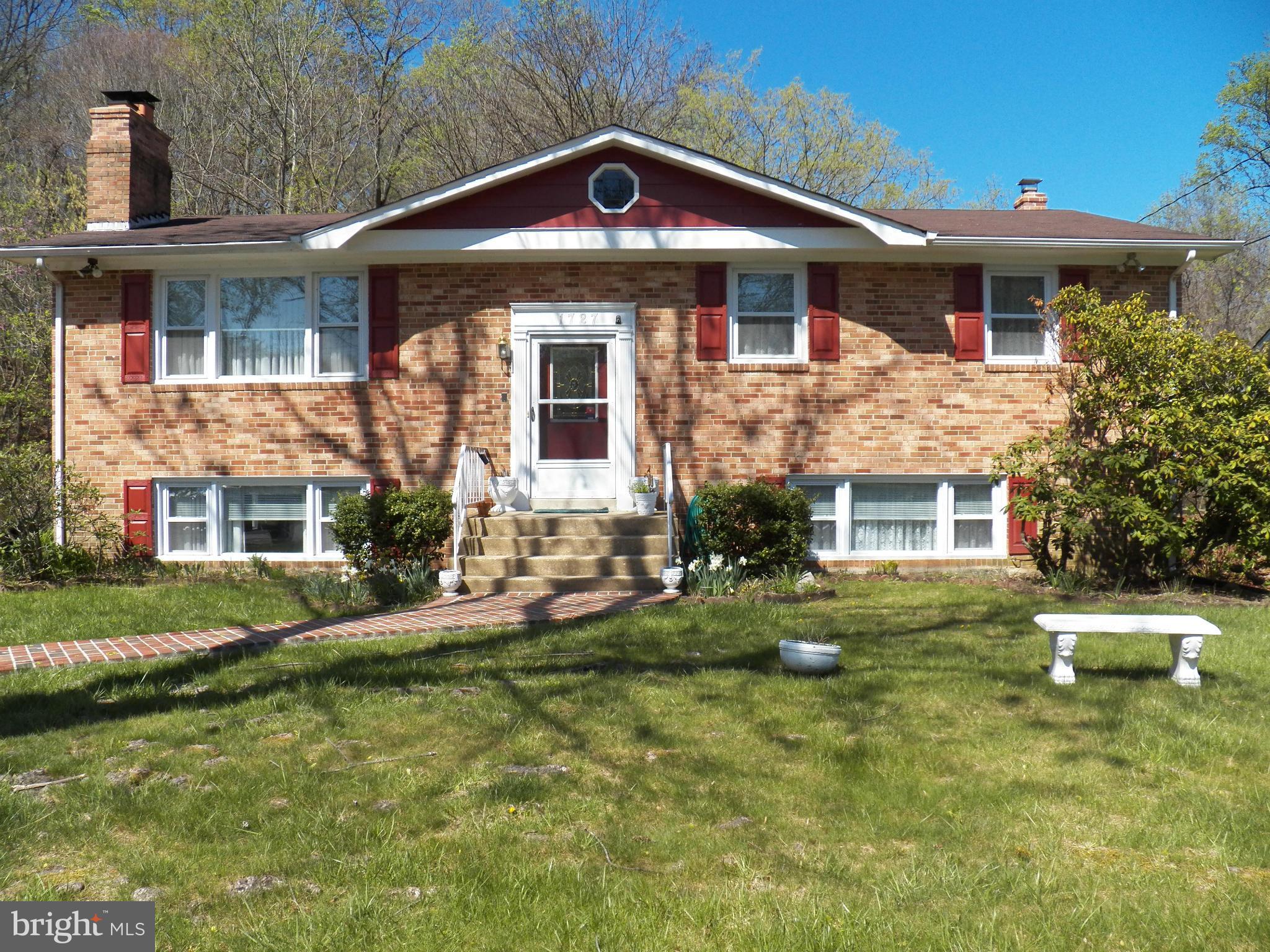ALL BRICK HOME ESSENTIALLY ONLY 15 YEARS OLD*HOUSE WAS TOTALLY REBUILT DUE TO FIRE*GUTTED AND REBUILT*MAIN LEVEL BOASTS NICE EAT IN KIT*SEP DR*LARGE LR W/BRICK HEARTH FP*GLEAMING HARDWOOD FLOORS, 3 BR'S AND 2 FULL BA*DECK OFF UPPER LEVEL BACKING TO WOODS*DOWNSTAIRS HAS HUGE REC RM W/2ND BRICK FP, WET BAR, BEDROOM, 1/2 BA AND STORAGE*WALK OUT LEVEL TO CONCRETE PATIO*GREAT COMPLETELY UPDATED HOME