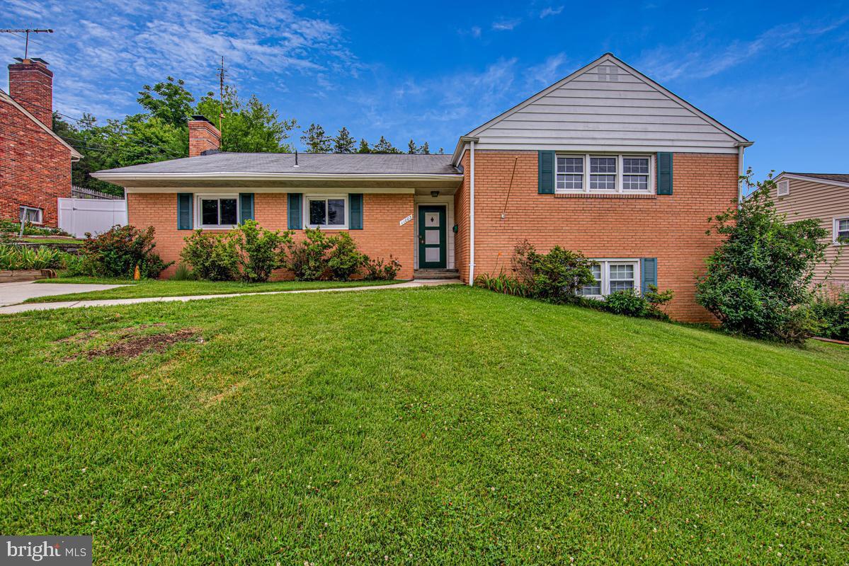Large brick four bedroom, three full split level. Upper level consists of primary bedroom with full bath and walkin closet and two additional bedrooms with another full bath. Hardwood floors. Main level consists of living room, formal dining room, eatin kitchen and wood burning fireplace. Lower level has large recreation room with built in bookcases, laundry room and fourth bedroom with private bath. Full unfinished basement. Large deck overlooking back yard. Off street parking for four plus cars.