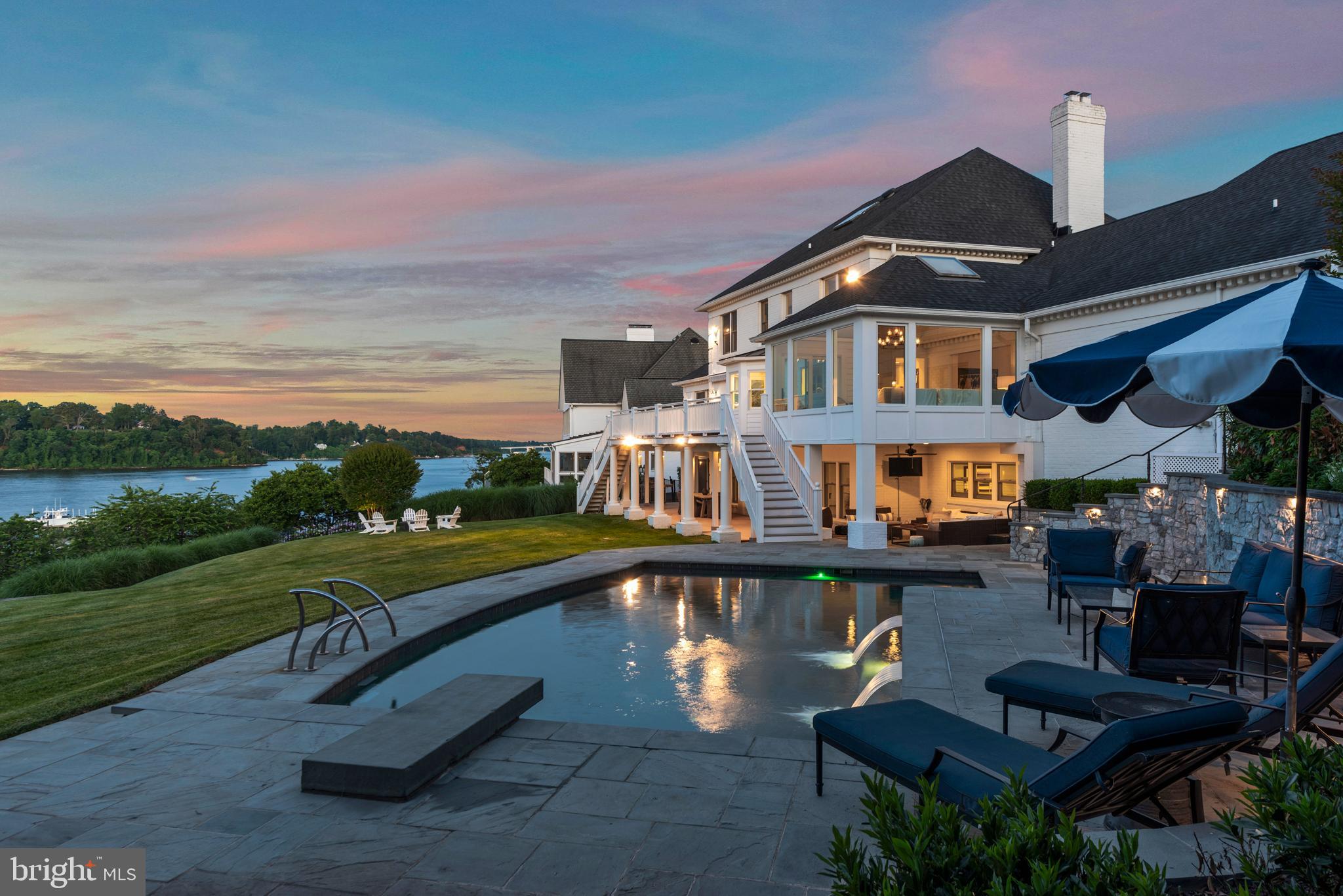 Experience  waterfront living from this  classic,  well maintained colonial located on the Point in The Downs,  one of Annapolis most sought-after waterfront communities. 
Featuring 180 feet of waterfront, unobstructed, elevated and sweeping views of the Severn River, a waterside pool, patios and decking, this all-brick home located on 1.16 acres is perfect for entertaining. Approved Permits in hand to build a  deep water pier for subject property .  Three finished, spacious levels of living space, hardwood floors, custom moldings and four fireplaces.  Enjoy the convenience of a first-floor master suite and 4/5 additional bedrooms,  sunroom, office and inviting  kitchen. Finished walk out lower level with  recreation room, bedroom, full bath, workshop/utility room.  Recent  improvement include new windows and doors, a tram to the water,  Sonos sound system,  security system and refurbished chimneys.