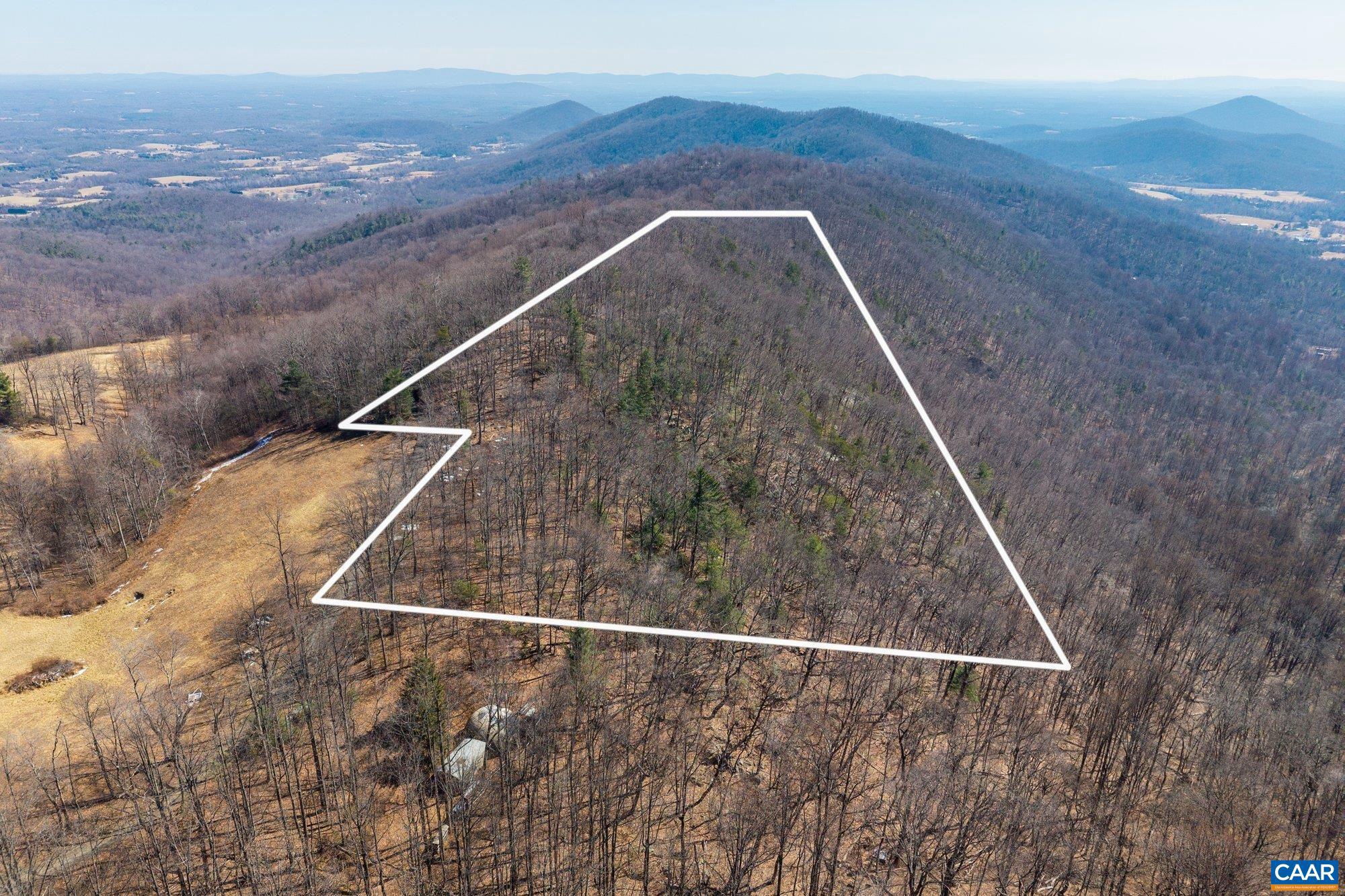 This 8-acre parcel adjacent to Stone Mountain Estate is entirely wooded, offering a private natural setting at a high elevation in Central Virginia. Mature forest blankets the property, creating a secluded landscape well suited for a future residence tucked among the trees. With selective clearing, the site has the potential to open long-range mountain views while maintaining a strong sense of privacy and connection to the surrounding landscape. Located within convenient reach of Charlottesville, the University of Virginia, and the region?s cultural and outdoor amenities, this offering is part of the larger Stone Mountain Estate listing with 78.99 acres.