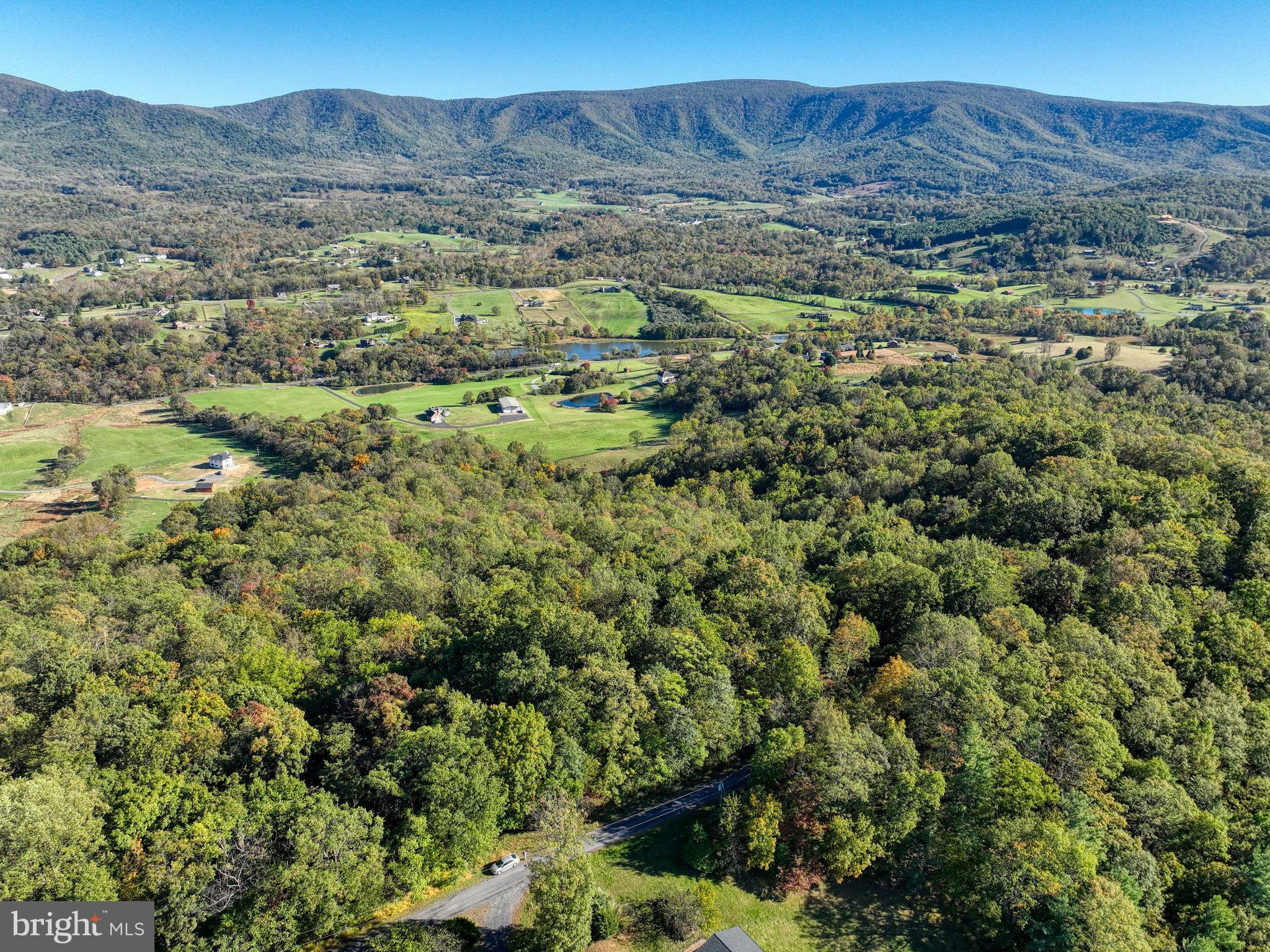 Rarely available lot in Seven Oaks, a private community of 16 homesites perched on Long Mountain with dazzling views of the Shenandoah Valley. Build your dream home in a community that covets privacy and peace (HOA restrictions do not allow short-term vacation rentals). Clear a few trees to enjoy an east-looking vista of pastures, woods and mountains stretching for MILES!  Lot is approved for a 4-bedroom home with conventional septic, and includes a proposed drainfield site. Real-estate signs and red ribbons on trees mark approximate property corners. Gravel road up the mountain is well-maintained by the HOA; surrounding roads in the valley are now paved. Located just 10 miles from Front Royal, minutes to Shenandoah National Park, the Shenandoah River, and Andy Guest Park--a nature-lover's paradise!