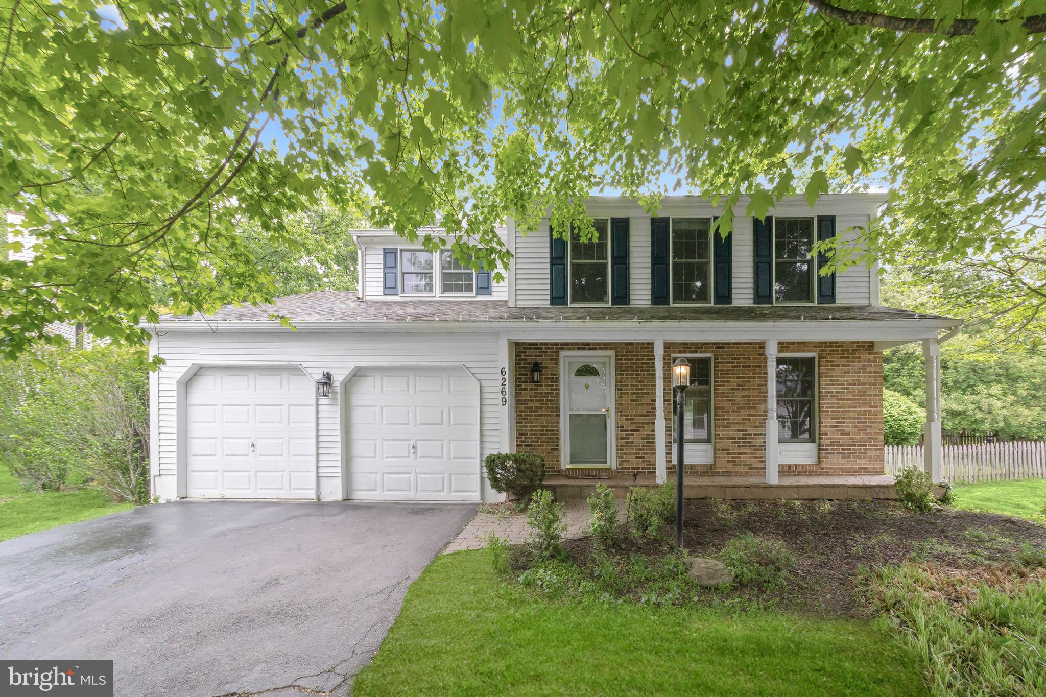 Buyers backed out because their car could not fit over the curb. Beautiful Colonial nestled in a vibrant Columbia community, thoughtfully refreshed with fresh paint and new flooring throughout. A charming covered front porch welcomes you inside to a sun-filled living room that flows seamlessly into the dining room, highlighted by elegant accent molding and direct access to the spacious deck, perfect for indoor-outdoor entertaining.The kitchen is both stylish and functional, featuring a center island breakfast bar, granite countertops, wood cabinetry, stainless steel appliances including an LG InstaView refrigerator, and an open layout to the inviting family room. Here, a cozy wood-burning fireplace flanked by built-in bookshelves creates a warm focal point, while a sliding glass door provides additional deck access.Upstairs, the primary bedroom impresses with a soaring vaulted ceiling, a walk-in closet with an organization system, and a private full bath. Three additional bedrooms and a hall bathroom complete the upper level.The finished walkout lower level offers a spacious recreation room and abundant storage options. Outside, enjoy a beautifully landscaped, fenced backyard with a large deck and mature shade trees, offering privacy and a serene setting.Ideally located near major commuter routes, shopping, dining, and entertainment, this home combines comfort, convenience, and classic Colonial charm.   Immediate occupancy available! Shared driveway with one other property. Sewells Orchard community offers tot lot, pet waste stations, sewells orchard  park, common areas, rain gardens. Fireplace was bought in AS IS condition and is conveying in AS IS condition