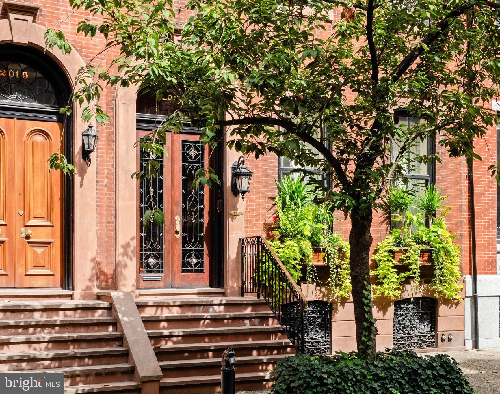 The striking 23’-wide historically significant brownstone at 2013 Delancey Place presents an opportunity to acquire an extraordinary property designed by the illustrious William Eyre. A masterpiece of architectural grandeur, artisanal craftsmanship and timeless elegance.

The Parlor Level’s wide entry gallery, grand staircase and 11.5 foot mirror framed in 24-carat gold welcomes you to the home, setting the stage for the glorious charm of yesteryear with original doors, fireplace mantels, flooring, and moldings—each telling stories of their own. The first floor greets you with impressive 12.5-foot ceilings and one of the nine fireplaces that grace this home, creating an atmosphere of warmth and sophistication.

The second floor receives you with an opulent hall and features a new Johanne Hudson kitchen with Calacatta Gold and Pietra del Cardosa slabs, an expansive dining room with Venetian plaster walls, original french doors and perched at tree level, a remarkable 600 SqFt great room of your dreams with an original fireplace mantle, paneling, figurines, moldings and stained glass under inspiring 10.5-foot ceilings. Tucked at the rear of the floor is a bar room where peeling off to pour your guests a drink is a breeze. Share a cocktail and admire the fireplace, columns and rounded window bay that adorn this room.

Ascend to the third floor, where the primary suite awaits, complete with a magazine-worthy bathroom showcasing exquisite custom bronze and iron detailing by Amuneal, book matched imported Italian black Carrara marble, heated floors, arched halls and Venetian plaster. The third floor also hosts a guest suite with a full bathroom stretching the entire front of the home.

The fourth floor provides two additional large bedrooms, perfect for accommodating a variety of needs and a shared full bathroom in the hallway. Additionally there is a middle room currently used as a walk-in dressing room wrapped with bespoke mahogany doors and closets.

Spanning over 6,000 square feet on a 93’-deep lot through to Cypress, this home offers a canvas of possibilities with its graceful layout and 1,000 square feet above grade on the first floor currently un-finished ready for your personal touch.  Add an outdoor space above the garage ? Possibilities are endless. ** Virtual renderings show what the 1st floor could look like if you were to bring the entertaining areas to the 1st floor **

Nestled on Philadelphia’s most coveted block, picturesque, tree-lined and graced by the most imposing series of impeccably-preserved townhouses in the City, this property offers a one-car garage—a true gem in city living. Superlative elements abound throughout the interiors with major systems meticulously maintained, this home is as functional as it is beautiful. Whether you're captivated by its historical allure or eager to add your own chapter, 2013 Delancey Place is ready to welcome you.

By appointment only.