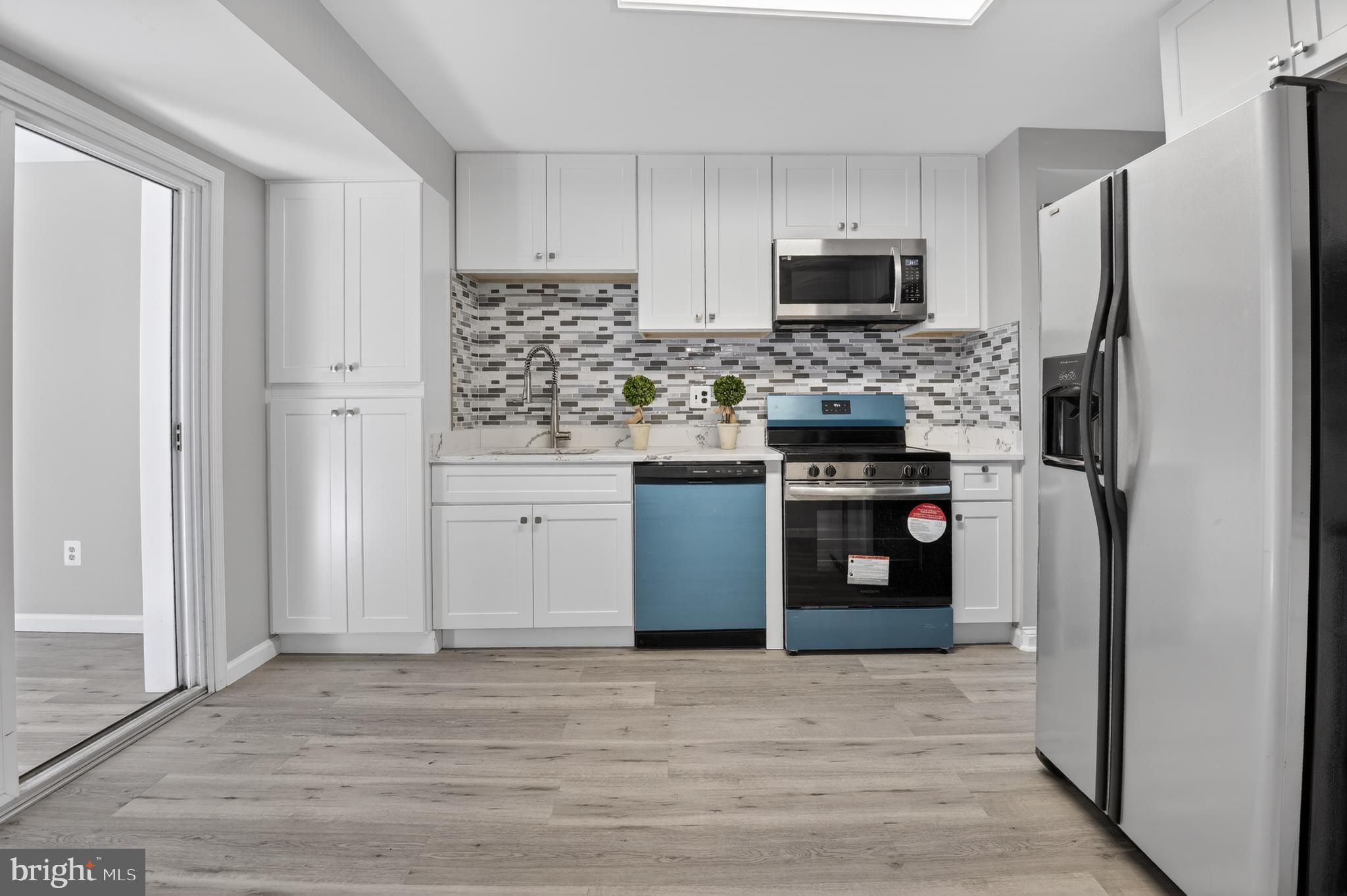 $50K PRICE REDUCED! All showings start on Friday, 6/4/26. ALL OFFERS DUE by 12 noon on Monday, 6/8/26. 
"NO HOA! ABSOLUTE MOVE-IN condition! Professionally UPDATED! NEW KITCHEN! NEW APPLIANCES! Park,  Children's playground, and a Tennis court are within a 3-minute WALKING DISTANCE.  New kitchen and stainless steel appliances, wood floors throughout.  Timeless Charm Meets Modern Living in the Heart of Glenview, Silver Spring
Welcome home to this beautifully reimagined all-brick colonial nestled in the sought-after Glenview neighborhood of Silver Spring. Thoughtfully renovated from top to bottom and offering approximately 2,500 square feet of living space, this 4-bedroom, 2-bathroom split-level residence blends classic character with today's modern comforts.
From the moment you arrive, the inviting curb appeal and timeless brick exterior create a sense of warmth and permanence. Step inside and feel instantly at home as natural light pours through skylights, filling the space with brightness and warmth. Beautiful laminate plank and ceramic tile flooring flow throughout, creating a stylish and welcoming atmosphere.
Imagine cozy winter evenings gathered around the fireplace in the spacious living room, sharing stories and creating lasting memories. At the heart of the home, the fully modernized kitchen shines with new flooring, sleek countertops, stainless-steel appliances, and a floor-to-ceiling pantry designed to keep everything beautifully organized. The adjacent breakfast area invites slow mornings with coffee, casual meals, and everyday connection.
This thoughtfully designed layout offers flexibility for modern lifestyles—whether you need space for entertaining, working from home, multi-generational living, or simply room to spread out and relax. The sunroom becomes your personal retreat—perfect for morning coffee, reading, yoga, exercise, or peaceful moments of meditation.
The main level also features a separate dining area, a convenient first-floor bedroom, and a full bath—ideal for guests or added accessibility.
Upstairs, the bright and airy primary suite feels like a private sanctuary, enhanced by skylights and generous walk-in closets that also feature natural light overhead. Two additional spacious bedrooms offer endless possibilities for family, guests, creative spaces, or home offices.
Step outside and discover easy outdoor living. The concrete patio is ready for summer grilling, weekend gatherings, or quiet evenings under the open sky. Situated on approximately 0.21 acres, the yard offers just the right balance—room to personalize without overwhelming maintenance.
Practicality meets convenience with a two-car garage and a private concrete driveway accommodating two additional vehicles. Tree-lined sidewalks and charming street lighting further enhance Glenview's welcoming neighborhood feel.
Location is the finishing touch. Peacefully tucked within Glenview yet less than a mile from public transportation, this home offers the rare combination of tranquility and accessibility—making commuting and enjoying nearby urban amenities such as shopping, dining, schools and parks effortless.
This is more than just a house—it's a place where comfort, style, and everyday living come together beautifully. Schedule your private tour today and experience the feeling of home for yourself."