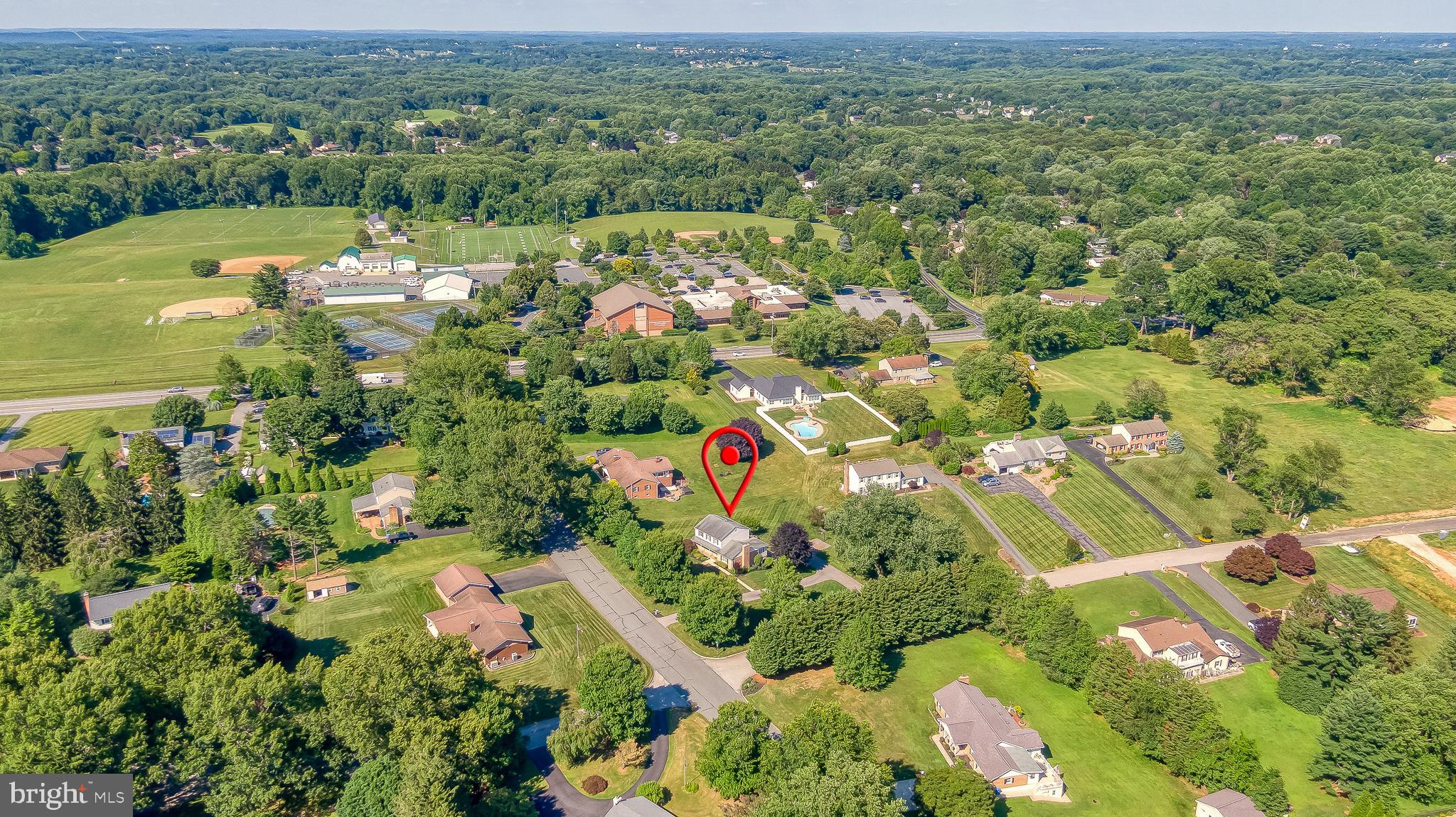 Walking distance to the Fallston rec fields, this beautifully maintained home features refinished hardwood floors and fresh paint. Just inside the door, you'll find a spacious family room with a soaring cathedral ceiling and a cozy pellet stove. The family room opens to a bright sunroom accented with crown molding and a bay window. The eat-in kitchen offers 42-inch cabinetry, granite countertops, stainless steel appliances, hardwood flooring, and a sliding glass door leading to the maintenance-free deck. The kitchen also flows seamlessly into the light-filled dining room. A convenient powder room completes the main level. Upstairs, the primary suite features a beautifully renovated ensuite bath, accompanied by three additional bedrooms and an updated hall bathroom. The finished walkout lower level includes a spacious recreation room with luxury vinyl plank flooring, a full bathroom, laundry room, and ample storage. Outside, enjoy a huge paver patio with retaining wall and fire pit, built-in storage shed, oversized garage, and plenty of driveway parking. This home offers the perfect combination of comfort, updates, and indoor-outdoor living.