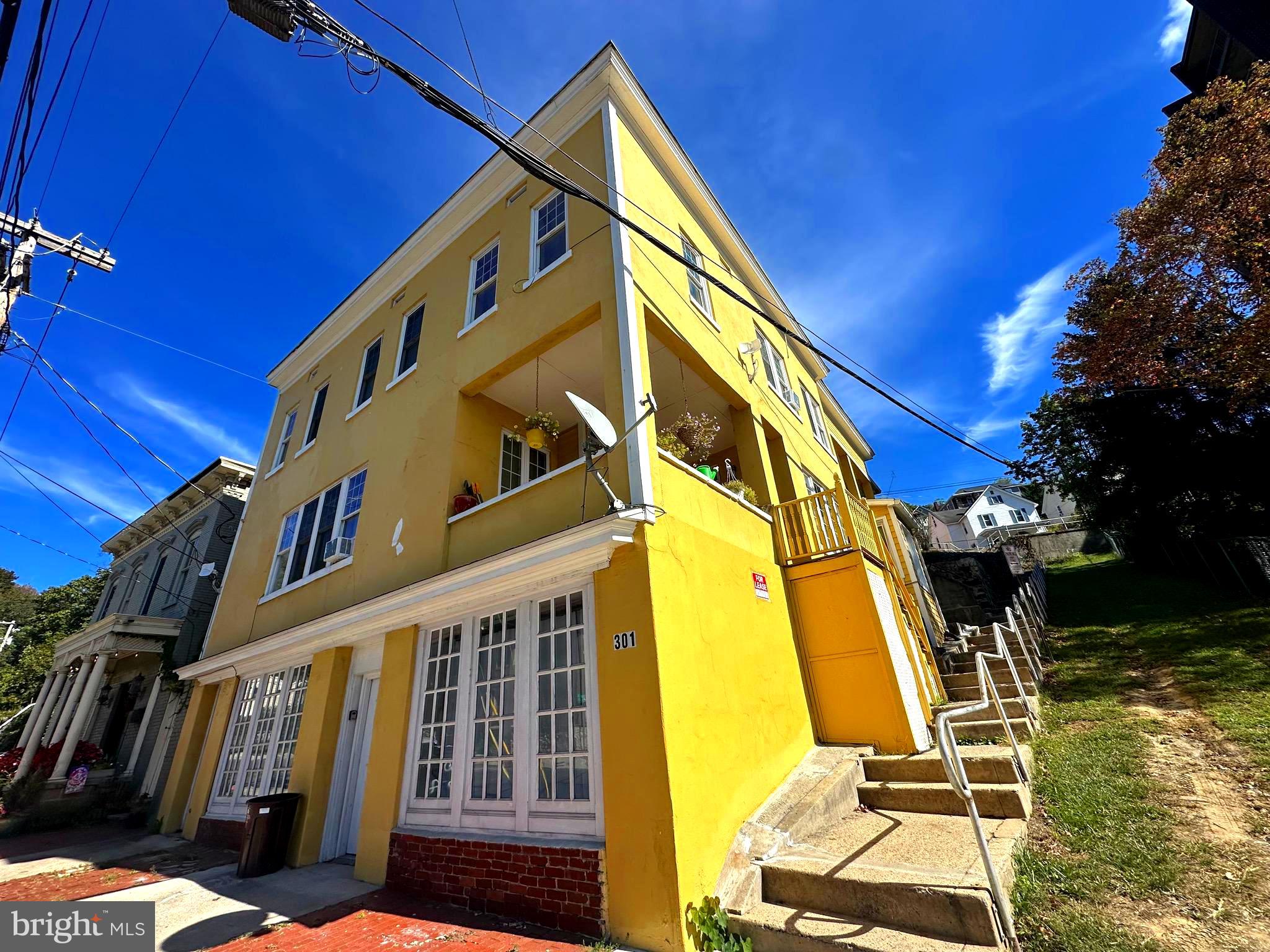An exceptional mixed-use investment opportunity in the heart of Cumberland. This well-maintained four-unit apartment building with a street-level commercial space offers strong in-place income, upside potential, and long-term stability—all in a convenient downtown location near shops, dining, and everyday amenities.

The property is largely occupied and thoughtfully updated, making it a turnkey addition to any portfolio. The ground-floor commercial space features prominent street-facing windows, ideal for office, retail, or storage use, creating an additional revenue stream and flexibility for future tenants or owner use.

Each residential unit is separately metered for electric and water, helping minimize owner expenses and simplify management.

Unit Breakdown:
- Unit 1: 1BR/1BA — Rented at $901/month. Features hardwood floors, in-unit laundry, and a new hot water heater.  
- Unit 2: 2BR/2BA — Rented at $822/month. Currently undergoing improvements, including new flooring in one bedroom.  
- Unit 3: 2BR/2BA — rented at $950/month. Offers hardwood floors, in-unit laundry, an open kitchen with island, and stunning city and mountain views—prime for immediate lease-up at market rate.  
- Unit 4: 1BR/1BA — Rented at $900/month. Recently updated with new carpet and flooring, fresh paint, new countertops, and a new hot water tank. Includes central air.

Additional improvements include a fully waterproofed basement (2024) with a new sump pump, providing peace of mind and reduced maintenance concerns.

With multiple income streams, solid rental history, and value-add potential through lease optimization and commercial use, this property delivers both immediate cash flow and long-term appreciation in a steadily revitalizing downtown market.