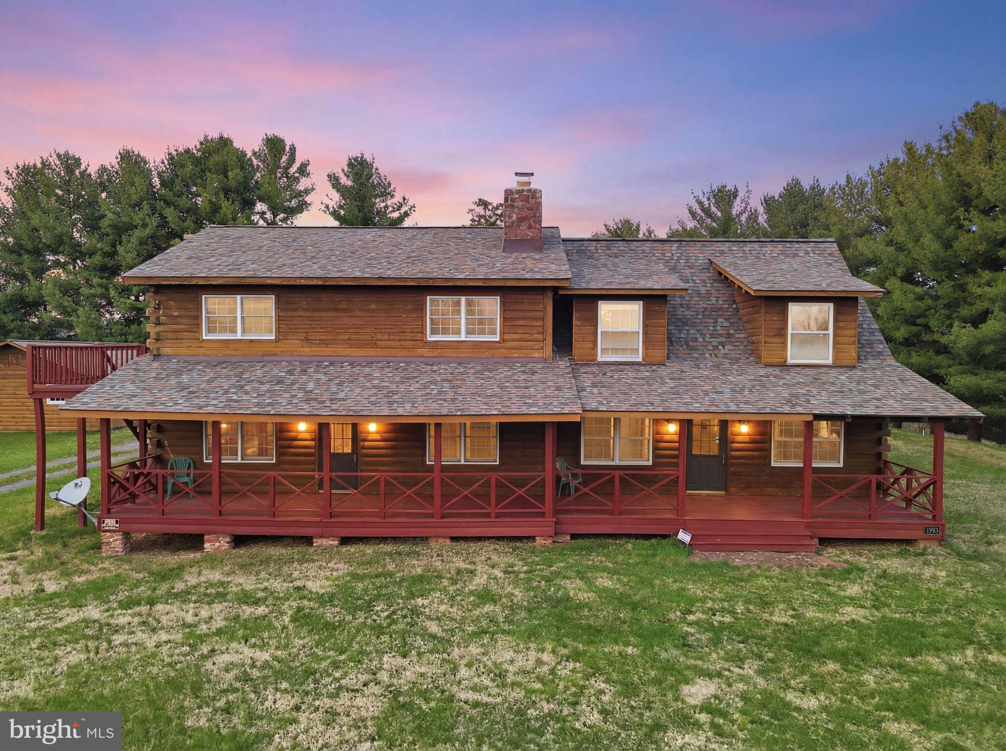 Discover this exceptional luxury log home at 21142 Westerly Rd, Poolesville, MD, beautifully situated on 13.5 private acres in a highly desirable location. Offering 4 spacious bedrooms, 3 full bathrooms, and 1 half bath, this remarkable property blends rustic elegance, comfort, privacy, and timeless charm.
As you approach the front of the home, you are welcomed by a large, spacious deck, perfect for relaxing, entertaining, and taking in the peaceful surroundings. Upon entering, you are greeted by a spacious family room featuring a real wood-burning fireplace that opens seamlessly to the kitchen, creating a warm and inviting atmosphere.
The kitchen offers abundant space and is equipped with commercial-grade Viking stainless steel appliances, including a refrigerator and wall oven, along with a convenient electric cooktop. This luxurious custom-built home is thoughtfully designed for both everyday living and entertaining. Just beyond, you will find a living room with an additional fireplace, adding even more warmth and character to the home.
The main level also features a separate bedroom with its own full bathroom, ideally situated for guests or multigenerational living. The laundry room is conveniently located on the main level and includes a sink and a fold-down ironing board for added functionality.
Upstairs, you will find two additional bedrooms with beautiful sky views and a full bathroom located across the hallway. As you continue toward the primary suite, you are welcomed by an open ceiling and a stunning stone fireplace that rises from the living room below, creating a dramatic architectural focal point. The spacious primary suite offers a luxurious en-suite bathroom complete with a jetted Jacuzzi tub and a separate stand-up shower. The primary bedroom also features its own private deck, providing the perfect place to relax in the early morning or evening while admiring the scenic views with a cup of coffee or a late-night snack.
The lower level features a huge family room with a real wood-burning fireplace, a half bath, and a private exit to the outdoors, offering excellent additional living and entertaining space. This level also has its own heating system and separate controls for added comfort and convenience.
Surrounded by scenic natural beauty, the property includes a private pond and a long circular driveway, enhancing both the sense of arrival and the privacy of the setting. A detached 3-car garage with a workshop provides ample space for vehicles, storage, hobbies, or projects. Additional highlights include a brand-new roof and an all-electric geothermal heating system, offering efficiency and peace of mind.
With expansive acreage, breathtaking sunset views, and exceptional craftsmanship throughout, this one-of-a-kind property offers the rare opportunity to enjoy luxury country living at its finest.