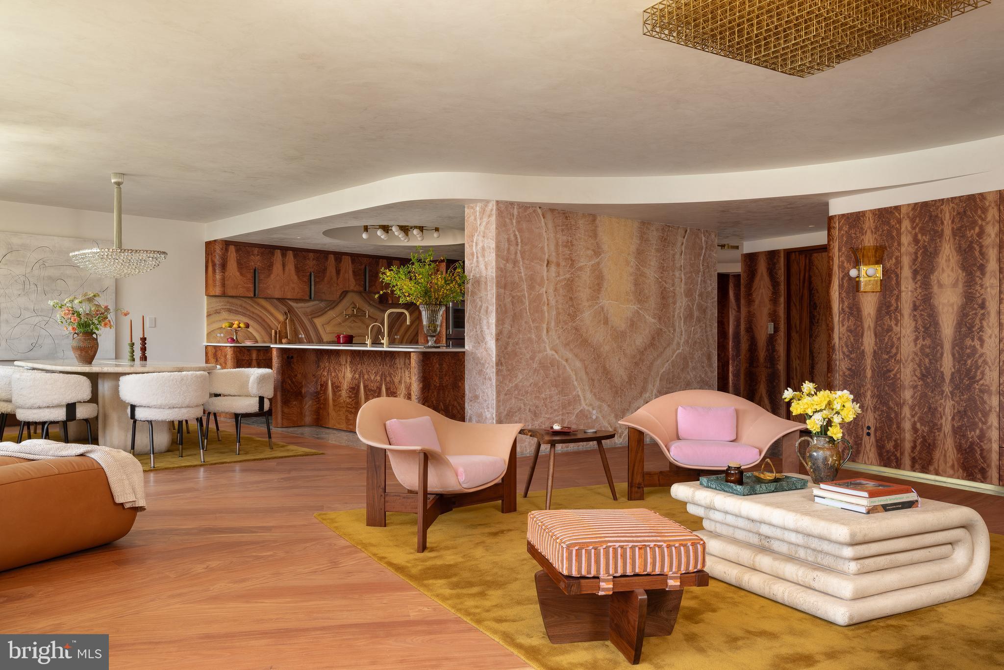 A rare opportunity to own a masterfully reimagined residence within Washington's iconic Watergate. Occupying a prime position on one of Watergate South's highest floors, this extraordinary combined apartment seamlessly blends the building's celebrated architectural heritage with sophisticated mid-century modern design. Thoughtfully renovated from top to bottom with meticulous attention to detail, the residence showcases exquisite custom millwork, book-matched Okoume wood veneers, rich natural stone surfaces, bespoke lighting, and luxurious finishes throughout.

Designed for both grand entertaining and comfortable daily living, the flowing floor plan embraces the Watergate's signature curved architecture, creating elegant, light-filled spaces connected by thoughtfully crafted transitional moments that pay homage to the original design while introducing a fresh contemporary vision. The gracious living and dining rooms frame breathtaking views of the Potomac River, Washington's monuments, and the city skyline, while the chef's kitchen offers an exceptional setting for both intimate gatherings and large-scale entertaining.

The private quarters are equally impressive. A quiet study and library provide a sophisticated retreat, while the primary suite serves as a sanctuary of luxury with spectacular river views, custom-designed storage, and a remarkable semicircular spa bath inspired by the finest boutique hotels. The expansive dressing room rivals those found in the world's most exclusive residences.

Throughout the home, extraordinary finishes and materials were commissioned from renowned artisans and makers, including PE Guerin, Heath Ceramics, and highly skilled local metalsmiths, gilders, and cabinetmakers. Rich textures, layered materials, and atmospheric tones create an interior that evokes the glamour of late twentieth-century design while remaining serene, timeless, and exceptionally livable.

Widely recognized for its exceptional design and craftsmanship, this remarkable residence has been featured in leading international design publications, including Architectural Digest and Vogue Living. Located within one of Washington's most prestigious full-service cooperatives, residents enjoy 24-hour concierge service, security, beautifully maintained grounds, and unparalleled access to Georgetown, the Kennedy Center, the National Mall, and downtown Washington. Combining world-class design, iconic architecture, and an irreplaceable location, this is Watergate living at its absolute finest.