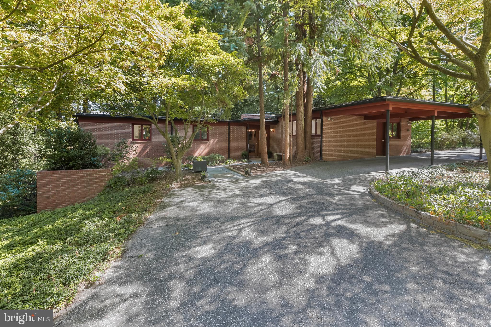 Cozy and hidden from sight quietly sits a custom brick mid-century modern home on a private, wooded lot. A nature lovers delight, enjoy the multitude of birds and wildlife from this property!  A path to a small bridge leads to a lily pond full of koi and frogs in the middle of the circular driveway in front of the house. Another path by the pond has an inviting bench on which to sit and enjoy this beautiful property.  Two driveways enable access on this .63-acre corner lot.

Walk along the stone path to the front door with covered entryway. Opening to the central foyer, there are beautiful, beamed wood ceilings and painted wood paneling throughout most of the main floor and walls along the stairs to the lower level. Step up from the foyer to the living room and woodburning fireplace to the right of the foyer.  The living room flows to a light filled sunroom with a glass roof and curving wall of windows descending from the roof overlooking the beautiful, wooded backyard and terrace. The dining room adjoins the kitchen, and there is a large laundry room next to the kitchen. Conveniently carry your groceries from the secondary entrance inside the carport into the kitchen. To the left of the front door is a hallway leading to three bedrooms and two full baths.  The primary bedroom overlooks the wooded backyard of the property and opens into a large sitting room.  The above-ground lower level has a generously sized recreation room, an additional room that could easily be used as a fourth bedroom (and indeed, was used as such in the past), and a utility room. An exterior door from the recreation room opens to a path and small patio leading to a storage shed that is built into the house and the side yard.

This warm and welcoming home is centrally located on Gibson Island. It would make the perfect getaway or primary residence. Still under original family ownership, the house was designed and built by its architect owner in 1957.  If you seek a small foothold on Gibson Island in a beautiful, wooded location with the option of one level living, this house is for you!

Information on Gibson Island:
Gibson Island is a private island within one hour of Washington, D.C. and Baltimore offering an absolutely extraordinary setting.  The Island comprises 1000 acres with seven miles of shoreline. Two thirds of the Island is undeveloped and is owned by the Gibson Island Corporation, the homeowners' association.  The remaining third is residential home sites. 
Gibson Island is located on the western shore of Maryland, so there is no need to cross the Bay Bridge. On the Island is a 43-acre spring fed freshwater lake in which one may enjoy non-motorized watercraft activities such as paddleboarding, canoeing, kayaking, fishing and swimming.  
The Island offers enormous privacy and security--there is an entry gatehouse staffed 24+Hours and the Island is patrolled by the Gibson Island Police Force (GIPD).  The Gibson Island Corporation Service Department offers yard maintenance and landscaping and other services for homeowners.  There is a full-service yacht yard.   From the Island, it is just a 20-minute drive to BWI Airport and the neighboring Amtrak train station.  
The Island houses a private country club (membership by invitation) offering yachting, fine dining year-round, tennis, an award-winning Charles Blair Macdonald designed 9-hole golf course, swimming, croquet, skeet shooting, and more.  (C)