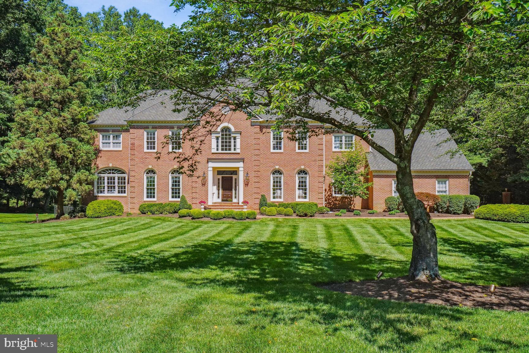 Welcome to your private McLean oasis on almost 2 acres.  Beautifully decorated and impeccably maintained, this home is nestled at the end of a cul-du-sac and surrounded by mature trees, lush landscaping and a well-manicured lawn.  

After driving down a long paver driveway, you enter this spacious center hall colonial through a gorgeous 2-story foyer with an elegant circular staircase. The foyer leads into a large 2-story great room with a magnificent stone fireplace, floor-to-ceiling windows and wet bar. To the right of the foyer is the formal living room with a gas fireplace which opens into the library with built-in bookcases. Off to the left of the foyer is a large, sophisticated dining room and adjoining butler’s pantry. The butler’s pantry leads to a renovated kitchen with top-of-the-line appliances and breakfast area. The breakfast area opens to a spacious sunroom.  The main level also includes a powder room, mud room and laundry room with sink.
The upper level includes 4 large bedrooms and 4 full en-suite baths, all of which have been updated (3 in the last two years). The primary bedroom features a cathedral ceiling, stunning bathroom and a large walk-in closet with custom built ins.

The walk-out lower level is great for entertaining with billiards table, wet bar and media area.  The 5th bedroom, currently being used as an exercise room, is on this level. The lower level includes a full bath and a bonus room (furnished as an office) with large walk-in closet. There is also a massive storage area and utility room.   

Outside, the private backyard paradise is fenced and includes a large screened porch and deck with plenty of room for entertaining.  Beyond this is the spectacular pool and spa.  The expansive pool area is accented by stone walls, lush landscaping, a custom designed arch and beautiful exterior lighting. There is a fully-equipped outdoor kitchen with top-of-the-line appliances, wet bar and a 65-inch outdoor Sunbrite TV, as well as, a custom stone fireplace with seating area.