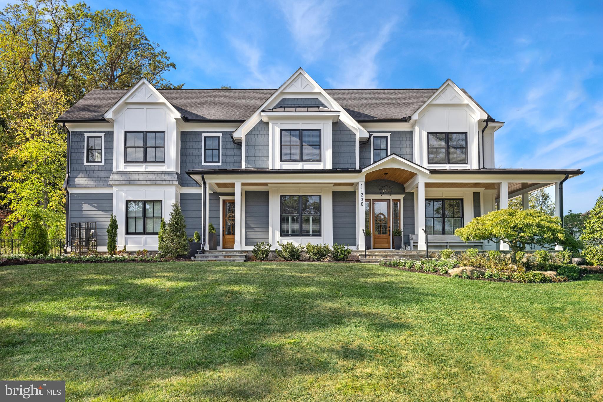 Luxury Defined in Luxmanor! Built by renowned Spring Valley Builders, LLC in 2021, this transitional craftsman style residence boasts a host of thoughtful improvements by its current owners that elevate it to the pinnacle of luxury living. With a great emphasis on outdoor enjoyment, the prominent .52-acre corner lot has been fenced in and gated, featuring a screened porch with a gas fireplace, a limestone terrace with a natural gas line for grilling, a customized irrigation and outdoor lighting system, an expansive grassed lawn, a bocce court and a hand cut granite wood-burning fire pit. The interior spans over 6,000 square feet of living space with five bedrooms that all have en-suite bathrooms and walk-in closets. Every detail of this home has been thoughtfully considered to create a truly exceptional living space. As you step into the Main Level entrance foyer from the wrap-around front porch, you are greeted with 10-foot ceilings, white oak hardwood flooring, and an abundance of natural light. Along the front of the house is the formal dining room with a connecting butler's pantry to the kitchen, a library or home office with pocket doors, a powder room, a coat closet and a large mudroom with a separate entrance as well as access to the 3-car side loading garage. Meticulously designed for modern living, the open floorplan in the back of the house includes a Gourmet eat-in kitchen with custom white Shaker style cabinetry, a large center island, Quartz countertops, SubZero and Wolf appliances, a walk-in pantry, and a breakfast area for informal dining. It seamlessly feeds into the oversized family room that has a beautiful, coffered ceiling and gas fireplace - perfect for entertaining! Off of the family room are wide sliding patio doors that lead out to the handsome screened porch and expansive outdoor living areas. The primary suite is situated in the back of the Upper Level and is spacious and quiet, offering two dressing rooms and a gracious primary bathroom that has two vanities, a walk-in shower, a soaking tub and a separate water closet. Completing this level are three additional bedroom suites, access to the fully insulated attic space, and a laundry room that features a GE smart front load electric washer and dryer, ample storage and a large sink. On the Lower Level of the home is the fifth bedroom suite, recreation room with a gas fireplace, media or game room, home gym or office, storage and utility room. This coveted North Bethesda neighborhood is conveniently located just minutes from Walter Johnson High School, Tilden Middle School and Luxmanor Elementary School as well as public transportation, Pike & Rose, The Shops of Wildwood, Cabin John Village, downtown Bethesda, the Beltway and I-270. Please inquire for a full list of Property Improvements and Additional Property Features!