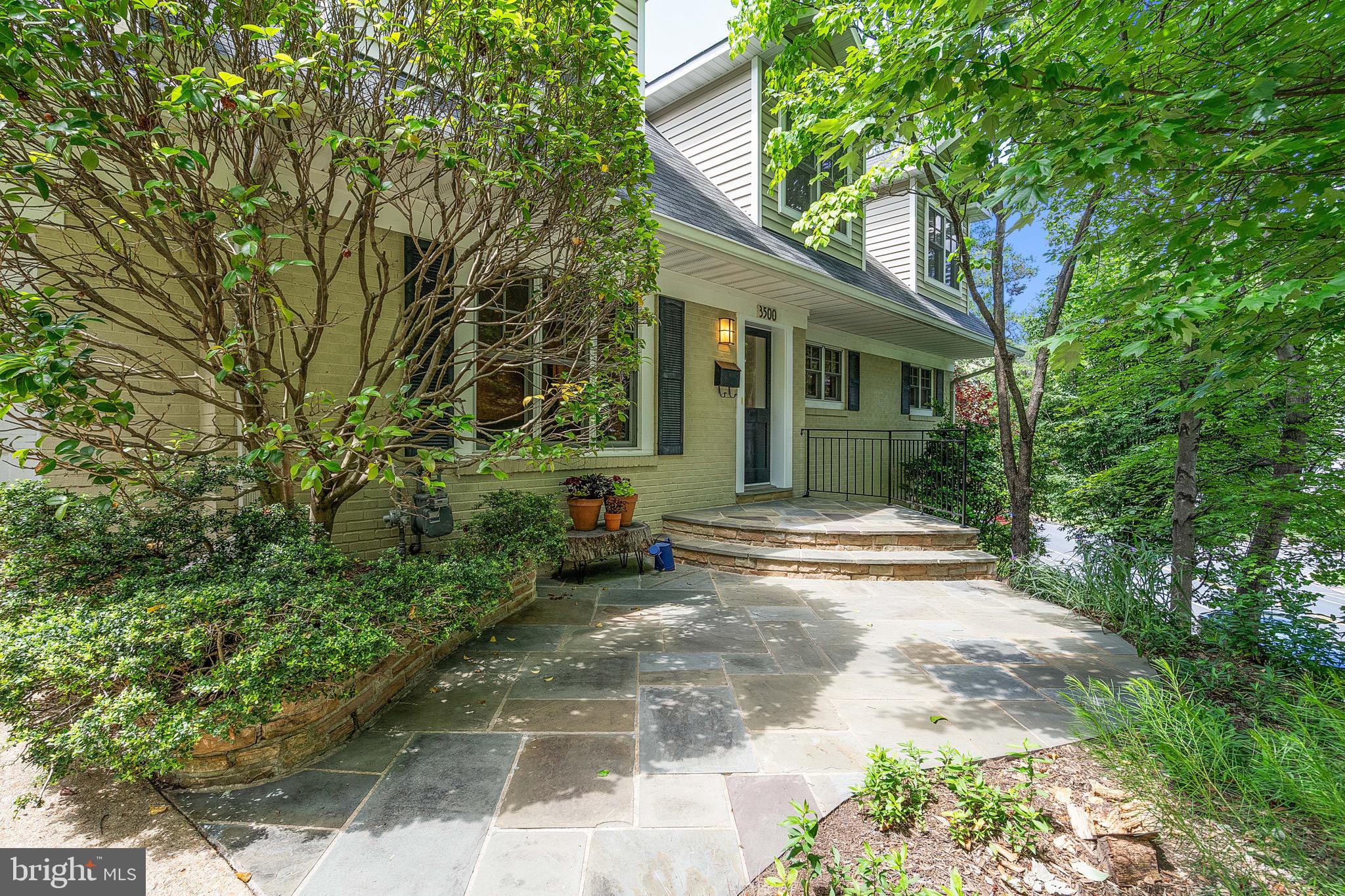 Set back from the road on a spacious 12,000+ sq ft lot, with driveway entrance on 35th St N, this expanded and renovated three-level home offers over 3,550 square feet of thoughtfully designed living space in North Arlington. Blending comfort and architectural charm, the home features refined details including solid wood trim and doors, dormered upper-level bedrooms, and hardwood floors throughout the main and upper levels.
The main level offers a flexible layout to suit a variety of needs—create distinct spaces for living, dining, working, or relaxing. Custom built-ins and a wood-burning fireplace add warmth and function. The kitchen is designed with both style and performance in mind, featuring marble and stainless steel countertops, maple cabinetry, glass tile backsplash, open shelving, and professional-grade appliances. Glass doors from the kitchen and dining areas open to a flagstone patio—perfect for outdoor dining and entertaining. A spacious pantry and a mudroom were added to enhance everyday convenience.
Upstairs, 4 generously sized bedrooms include a spacious primary suite with a walk-in closet, sitting area, and en suite bath. A hall bath with dual sinks serves the remaining 3 bedrooms, and a linen closet provides additional storage.
The finished lower level offers newly carpeted space that can serve as a recreation room, guest suite, home office, and storage area, complete with a full bath.
Lush, mature landscaping provides privacy from the road, and the expansive backyard is fully fenced. The home is within the boundary to join the Donaldson Run Recreation Association pool - a community pool nestled at the base of Potomac Overlook Park.   Nature lovers will enjoy the nearby Gulf Branch nature center, the Donaldson Run paved walking/biking path, and hiking trails to the Potomac River, all within minutes of this home. And yet, you are also within easy access to Chain Bridge, GW Parkway, and the ART bus to Ballston Metro, for commuting to DC, Tysons, Bethesda, and beyond. Zoned for Jamestown Elementary, Williamsburg Middle, and Yorktown High School, as well as APS option schools such as Escuela Key Spanish Immersion. Driveway and street parking are available, and the shortened garage provides excellent storage for bikes, tools, and gear. Check out the 3D virtual tour or visit in person.