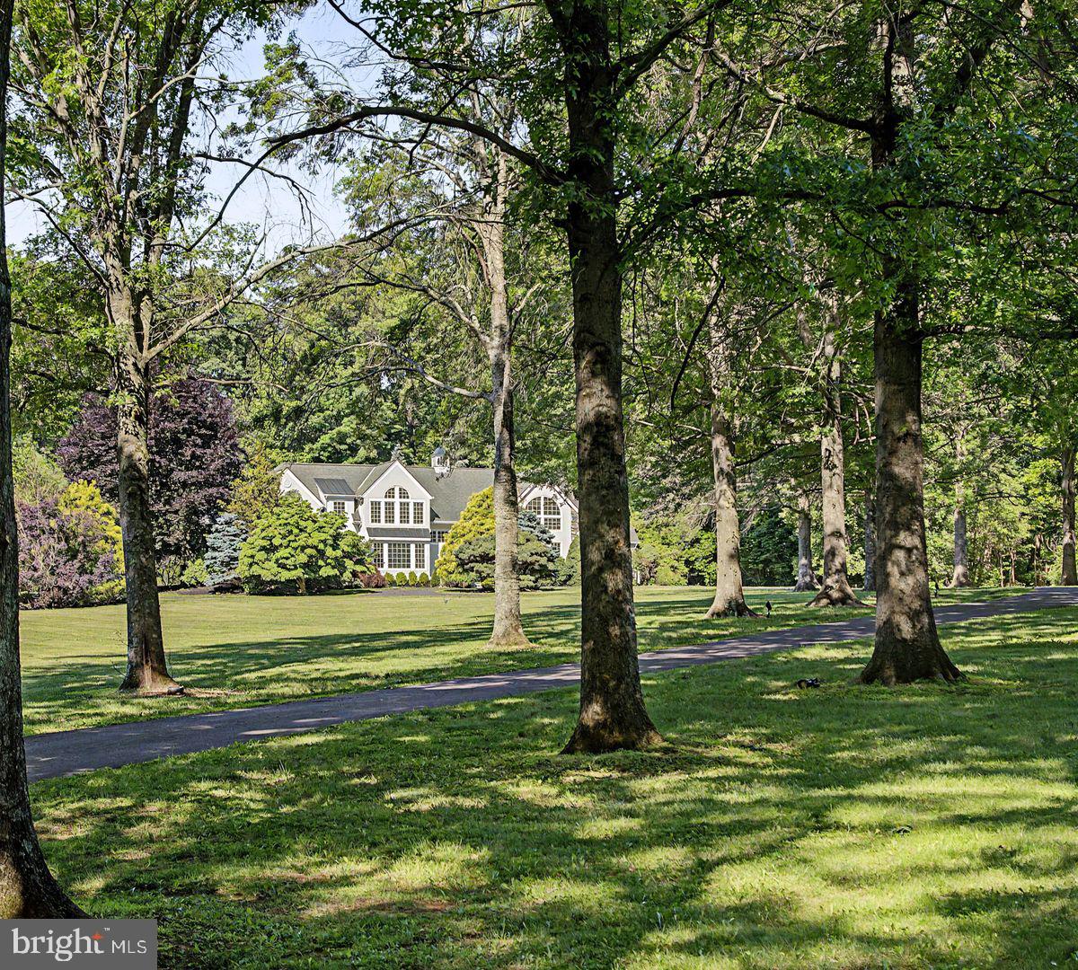 Set gracefully on 10+ private acres in the bucolic River town of New Hope, PA, this remarkable estate offers a rare sense of seclusion, where architecture and mature landscape unite in quiet harmony. A long, tree-lined drive winds past custom stone pillars, revealing a home that feel both grounded in nature and thoughtfully designed. Inside, light and texture define the interiors. A light-filled foyer welcomes guests with views of a stone fireplace and the bright living spaces beyond. The sun-drenched living room showcases soaring 20-foot ceilings, skylights, and a wet bar, creating an ideal setting for entertaining. The chef’s kitchen and pantry serves as the heart of the home, bathed in natural light and overlooking the pool. Enjoy casual meals with picturesque views, while the formal dining room with tray ceiling provides an elegant backdrop for gatherings. A charming sunroom with fireplace offers the perfect home office, or quiet retreat. The first floor also features a family room and game room. 

The flexible floor plan includes four bedrooms and five full baths and one half bath. A first-floor suite offers abundant natural light through expansive windows. Upstairs, a spacious primary suite serves as a private retreat, featuring two beautifully proportioned rooms filled with natural light, picturesque views from the elegant arched windows, an ensuite bath, and walk-in closet space. A newly installed second-floor laundry adds convenience and functionality to the upper level. Another spacious en-suite and 3 additional bedrooms with a shared full bath complete the second floor. Additional amenities include a three-zone geothermal heating and cooling system, water heater, three-car garage and a heated pool. A property of this caliber is increasingly difficult to find—offering acreage, privacy, and a beautifully updated home in the heart of New Hope, where nature, comfort, and accessibility come together in perfect balance. 90 minutes to Manhattan, 70 minutes to Philly.