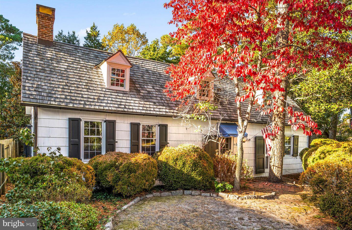 Nantucket in Rehoboth Beach. Own a piece of history at 69 Henlopen Avenue, one of the most distinctive properties in "The Pines" neighborhood of Rehoboth Beach! This remarkable home, crafted in the 1940s, brings together several smaller historic structures dating back to the early 1900s. This architectural gem is set on a generous 100' x 91' parcel offering space and privacy. The property’s cedar shake siding, cedar roofing, onion globe lanterns, brick walkways, and mature trees and landscaping exude classic and timeless curb appeal. Step inside and journey back in time. Original wide-plank hardwood floors, carefully curated period furnishings, and exquisite vintage details transform every room into a work of art. With over 4,900 square feet of heated living space, this residence offers seven wood-burning fireplaces, three staircases, exposed wood beams, and masterful craftsmanship throughout. The home’s spacious layout includes 5 bedrooms, 3.5 baths, a formal living room, an inviting study, a formal dining room, and a sunroom, all designed with comfort and character in mind. The kitchen features marble countertops, stainless steel appliances, and a convenient wet bar, making it both beautiful and functional. Outside, a private rear yard provides a peaceful escape, ideal for entertaining or quiet reflection. Located just a short stroll from both the ocean and downtown Rehoboth Beach, this extraordinary property offers an unmatched blend of history, style, and convenience. Embrace the opportunity to own this truly unique piece of Rehoboth’s rich heritage!