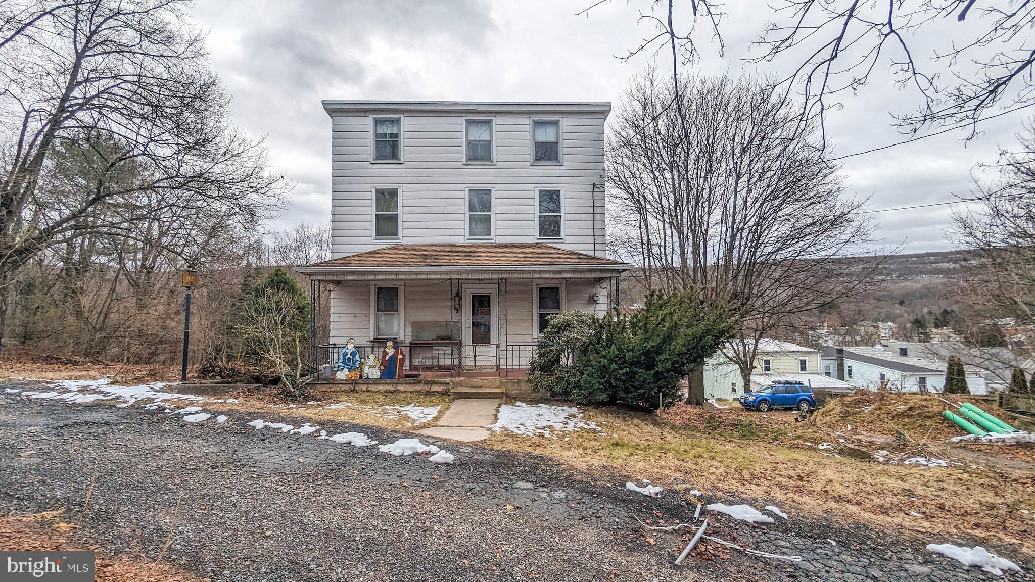 This 4/5 bedroom detached home in Middleport, Pa., presents a great opportunity for investors or fixer-upper enthusiasts. Nestled on a private road, property is ready for new owner to bring to life with love and updates. With spacious layout, home offers the potential for customization and transformation into a dream residence. Step into comfort on the first floor, where a cozy living room welcomes you. Adjacent is versatile space that can be used as den or an additional bedroom. The spacious eat-in kitchen holds great potential for becoming a chef's dream, and it opens up to a large deck, providing a perfect spot for relaxation. On the first floor, you'll also find full bathroom and convenient laundry closet equipped with dryer. Moving to the second floor, discover four nicely sized bedrooms, two of which are connected, offering flexibility in their use. Full walk-out basement ensures ample storage space for your needs. Outside, the property boasts a detached garage and a covered front porch, adding to its charm. Situated on a generous 1.02-acre lot, this home provides both indoor and outdoor spaces for you to make your own. Home has fruit trees on property, including apple, pears, cherry and blueberry bushes. Located on private road. With a bit of imagination and effort, this property can transform into a delightful residence. Centrally located between Pottsville and Tamaqua, and Locust Lake State Park and Tuscarora State Park are both only 15 minute drive away. Sold as is.