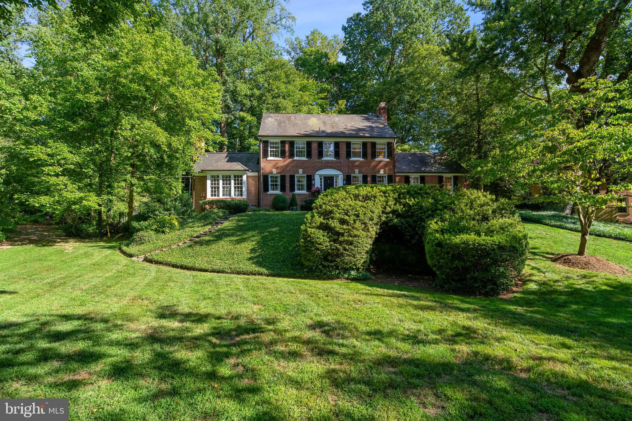 Classic and prominent Spring Valley center hall colonial in one of the neighborhood's most desirable locations. Perched upon a hill adjacent to the entrance of Spring Valley Park, 3601 Fordham Road exudes curb appeal, privacy and sophistication. The sweeping level front lawn and generous hardscape create an inviting entry to this stunningly designed home. Once inside, the discerning buyer will find a generous main level with 3 fireplaces spread across a traditional formal living and dining room, expanded family room with  three directions of sun filled windows and vaulted ceilings, an adjacent gourmet kitchen featuring updated countertops, an eat in breakfast area and French door access to a secluded and private rear garden/entertaining space ideal for alfresco dining.  An oversized study/1st floor bedroom with en-suite bath  offer yet another entertaining room or flexibility for additional guest accommodations. The 2nd floor has three full bedrooms (one which is currently being used as a walk in closet) including an owners bedroom that has its own ensuite bath and spans the entire width of the home. Two additional and surprisingly large bedrooms and a shared bath in the dormer eaves of the house provide even more guest space. The lower level provides ample storage, laundry facilities and direct access to the attached two car garage. A truly stunning offering that embodies the best of Spring Valley.