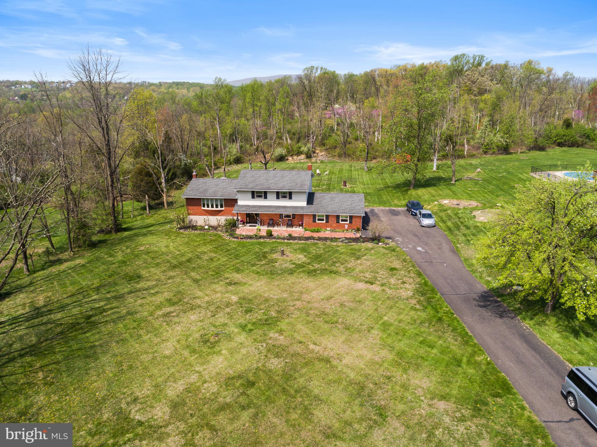 Delight in the charm of this spacious split-level home, nestled in a peaceful, tree-lined neighborhood conveniently close to essential amenities. Recently listed, this 2+ acre property features three generously sized bedrooms, one full and one-half bathroom spread across a comfortable 1,851 SF of living space.

Enter to find a large, tiled foyer that gracefully leads to a sunlit living area, complete with a bow window. Adjacent to this is a dining area and a clean, country-style kitchen equipped with a refrigerator, wall oven, dishwasher, pantry, and cooktop. There's even space for a modest table or an island, making it a versatile hub for your culinary adventures. Open the SGD's to discover a two-tiered deck that offers serene views of the expansive, partially wooded backyard—perfect for entertaining or quiet contemplation.

The home's upper level features the primary bedroom and two additional bedrooms, each spacious enough for large furniture, and offers ample closet space. A large hall bathroom w/combined tub/shower as well as a linen closet ensures convenience for all. The lower level features a cozy recreation room with a half bathroom, coat closet, and sliding glass doors leading out to the lower deck. This space also includes a brick, wood-burning fireplace w/blower that promises warm, inviting evenings at economical cost.

Additional features include hardwood and Tiled flooring, a partial yet spacious basement with laundry facilities, two office/storage rooms, mechanicals, plus an exit to a quaint rear paver picnic area. An oversized two-car garage with attic space adds to the practicality.

With the lush, mature landscaping that greets every visitor, this home is a canvas awaiting your personal touch. Make it your sanctuary and enjoy all the seasons in style and comfort.