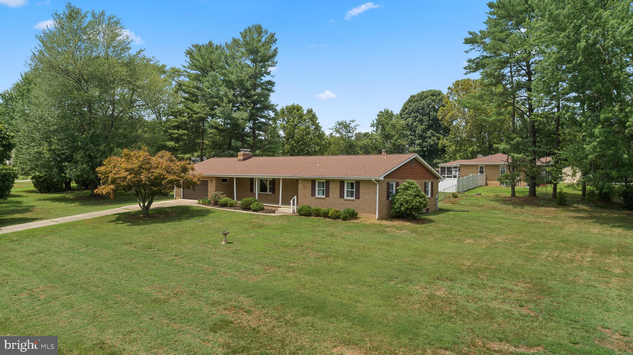 Full of possibilities, this spacious brick home is ready for a new owner to bring their vision to life. Built in 1973 and offering 3,671 total square feet, the home features three bedrooms, two full bathrooms, an attached garage, and plenty of space to customize.

A covered front porch welcomes you into the open living room, complete with a fireplace. The dining room includes doors leading to the backyard, while the kitchen offers wood cabinetry, a double sink, and a window overlooking the yard. An additional space with access to the attached garage and a side entrance could be transformed into a convenient mudroom or laundry room.

All three bedrooms are carpeted, including the owner’s suite with a private en suite bathroom. A second full bathroom includes a linen closet for additional storage. The completely unfinished basement provides a blank canvas for future living space, a recreation room, workshop, storage, or whatever best suits your needs.

Outside, the home features a large yard with a partially fenced backyard. With generous square footage and plenty of potential, this property is ready to be personalized and made your own.