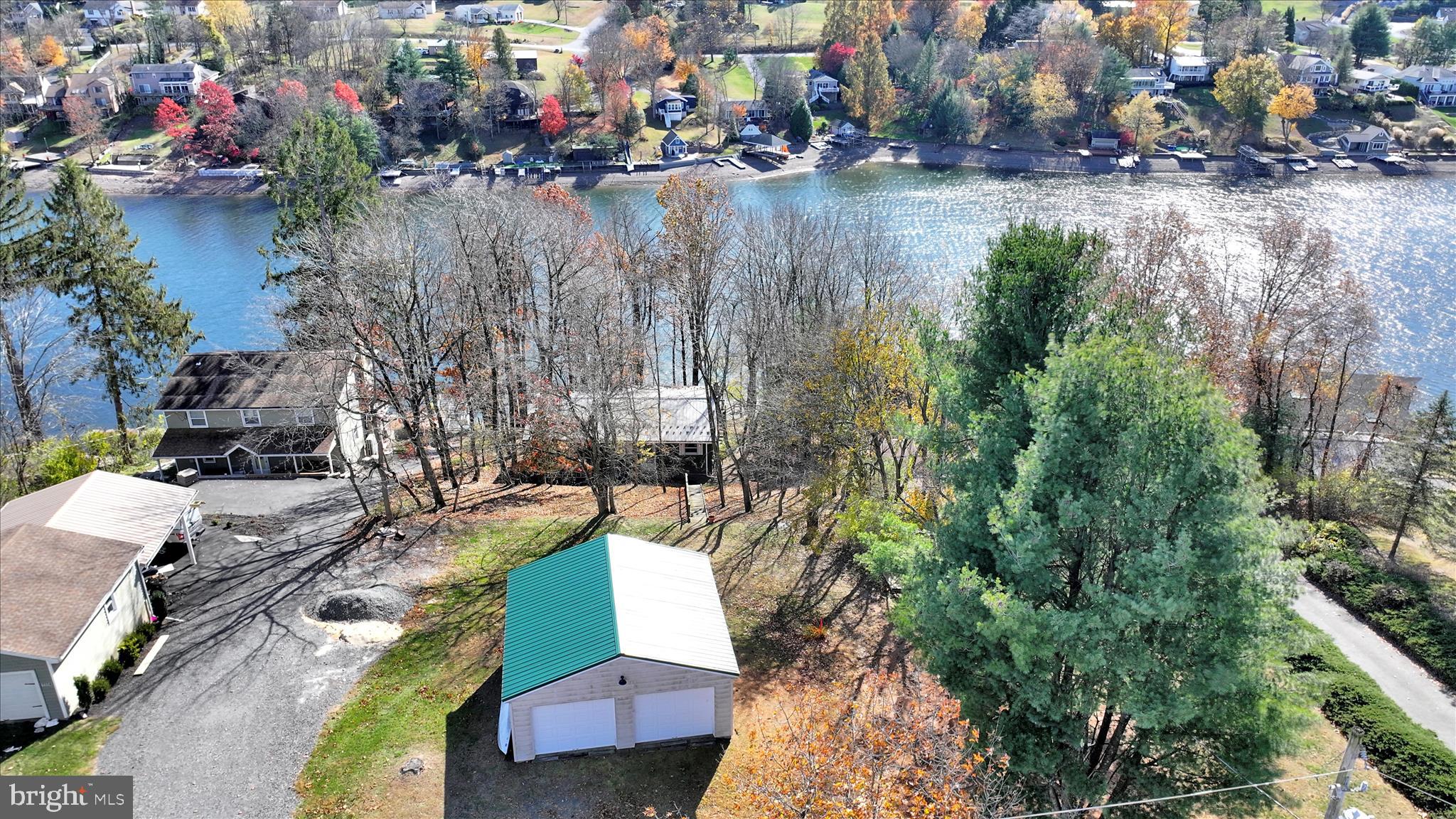 !!!Welcome investors and buyers seeking a good deal!!! POSITION YOURSELF FOR THE FUTURE - THINK FORWARD! Purchase this beautiful home at a reduced price due to the Lake Wynonah Dam rehabilitation project. Welcome to your meticulously maintained, personal mountain retreat in the beautiful, gated Lake Wynonah community. This charming three-bedroom, one-bathroom home offers a delightful blend of comfort and recreational possibilities. The main floor welcomes you with two bedrooms and a full bathroom, flowing seamlessly into a kitchen and vaulted living room for cozy evenings. Enjoy sunrise views with your morning coffee from the deck and quaint screened-in area. The fully renovated basement with walkout lower level transforms this home into something special, featuring a great room and spacious bedroom that could easily serve as your primary suite. You can certainly explore the possibility of adding another full bathroom in the basement. Area is plumbed for a second bathroom. Fresh paint brightens every corner, while the storage and utility area keeps life organized. The wood stove is disconnected and included with the sale. The basement patio access means you're never far from outdoor enjoyment. But here's where things get exciting: a switchback path leads to your updated waterfront area, complete with electric and water hookups. Newer bulkhead and dock. An oversized, detached two-car garage provides ample space for vehicles and recreational toys. Recent updates include a newer metal roof on both house and garage. Located in a peaceful, tranquil setting with nearby mountains, this property offers the perfect escape from everyday hustle while remaining conveniently close to essential amenities. Agents, please review Private Remarks and Documents. Schedule your tour today; Lake Wynonah is conveniently located about an hour from Harrisburg, Allentown and Lancaster and close to Philadelphia and nearby suburbs. Please call the Lake Wynonah Business Office for updates regarding the Lake Wynonah Dam. Boating is restricted to electric/trolling motors only while the Lake Wynonah Dam is being rehabilitated. Some photography displays Lake Wynonah at full pool. Please call the Lake Wynonah Business Office for updates on the "big lake"/Lake Wynonah Dam rehabilitation project and probable future assessment.  Taxes may not reflect 2026 assessed value.