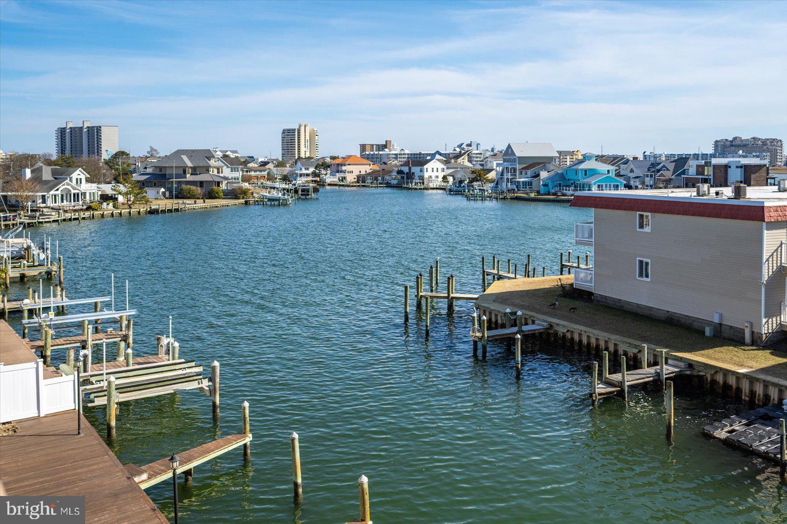 Views for miles! For buyers who demand quality and... an assigned boat slip. Gutted down to the studs and completely remodeled in 2024 by The Cypress Group Limited, one of the area's premier remodeling contractors. Every detail was considered (even the things you can't see!) From leveling the floors throughout the unit before laying Cortec scratch-resistant luxury vinyl plank flooring to ensure the future integrity of the flooring, to insulating along exterior wall/ceiling junctions and between units after original panelling was removed (for efficiency and sound barrier). All new electrical and plumbing throughout. A highly efficient ductless mini split system replaced the old wall AC units and baseboard heaters. The kitchen was gutted and redesigned to feature a massive island with seating for 6, quartz countertops, custom cabinetry with soft close doors and drawers. The primary bedroom entrance was reconfigured to allow for the creation of a laundry closet/pantry, removing the stackable unit from the kitchen, while creating a sense of separation from the other sleeping areas. Water heater was replaced with on-demand tankless system for energy efficiency and to free up closet space. Primary bathroom features walk-in shower with custom shower glass and custom surf themed tile.  All new windows and sliding glass door. All walls and ceilings were straightened and drywalled (goodbye panelling and popcorn!). Dramatic 3rd floor south facing views all the way to the 90 bridge and beyond, allowing all that beautiful sunlight to drench the balcony, even in the winter. Smart televisions in all bedrooms and custom plantation window shutters and  solid core shaker style interior doors complete the luxury feeling and quality workmanship that's so hard to find. Also features a nice sized designated enclosed storage area adjacent to the assigned figure pier.  On a quiet dead-end street. Unit comes furnished, turn-key and ready for you to begin making those beach town dreams a reality, or to rent it out to the most discerning vacationers. Storm shutters on balcony. Unit has only been occupied by owners as a vacation home since renovation was completed in 2024. Plans are in the works for canal-end bulkhead to be replaced. Current proposal is that each unit owner will contribute $1000 and the remainder will be covered by reserve funds. Association assigned "exclusive use" to specific boat slips for unit owners, unit 304 has slip 9. It is sellers' understanding that the original owners of the units that wanted to have slips, covered the cost of building their assigned finger pier. Unit is utilized by the current owners as a three bedroom, however per the town, it is technically a 2 bedroom + den. Agent is co-owner of the property.