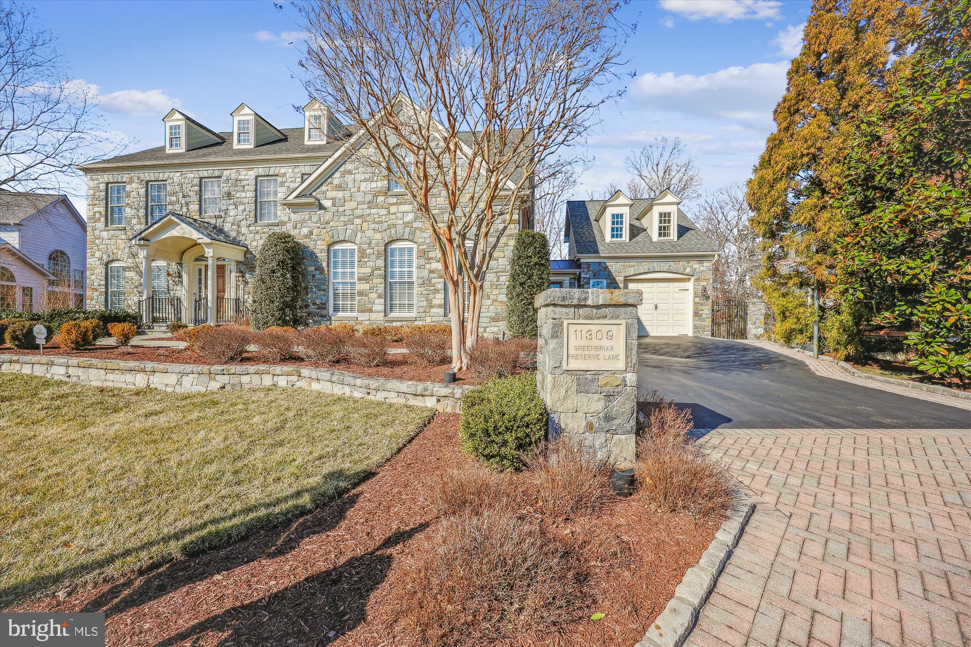 Prepare to be amazed by this meticulously maintained home, featuring an elegant stone façade that surpasses any other in the neighborhood. A thoughtfully designed addition includes a spacious garage and a versatile flex room above. The gourmet kitchen is a chef's dream, boasting a large island, stainless steel appliances, and an abundance of rich cherry cabinetry. The two-story family room is a showstopper, with an impressive stone gas fireplace, custom built-ins, and walls of windows offering serene views of conservation land. The fully finished walkout basement is a true gem with intricate molding and stunning stone accents throughout.  Also features a separate full kitchen, a luxurious stone wine cellar, and an abundance of built-ins for both functionality and style.  Descend the spiral staircase from the sunroom to an entertainer's paradise, where you'll find a stunning array of stone accents. The outdoor space is equally impressive, with a flagstone patio, a built-in grill and refrigerator, a grand stone fireplace, and a cozy stone firepit, perfect for gatherings. To top it all off, this home is equipped with a whole-house generator.