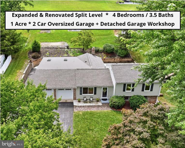 STUNNING VIEWS & UNEXPECTEDLY SPACIOUS HOME IN THE MIDDLETOWN SCHOOL DISTRICT! Discover a true retreat where you can enjoy breathtaking, panoramic valley sunset views right from your backyard oasis. Completely renovated and expanded in 2019, this unique home delivers incredible scale, thoughtful design, and premium quality upgrades throughout. THE MAIN LEVEL & LIVING SPACES feature beautiful luxury acacia wood floors in the family room and large-format tile in the standout chef's kitchen, which boasts an oversized quartz island, high-end Italian Sirius hood, and a large walk-in pantry. The kitchen opens to a spacious dining area anchored by a cozy fireplace with a custom black limba wood mantle, flowing effortlessly into a large 450+ sq ft family room addition complete with soaring vaulted ceilings and bright skylights. A dedicated work-from-home office, a laundry area with smart appliances, a spa-like half bath with elegant half-wall tile, and a durable mudroom with waterproof/scratch-resistant flooring complete this level. THE UPPER LEVEL offers 3 bedrooms and 2 full baths, featuring a clever pocket door connecting the primary and second bedrooms—an ideal flexible setup for a nursery or reading room. THE LOWER LEVEL provides incredible versatility, featuring a large recreation room with a sliding glass door walking out to the yard, a private 4th bedroom suite with its own full bath, and a utility room with an optional second washer/dryer hookup. UPGRADES include a specialized 4-zone HVAC setup (2 separate units), a German-engineered solar-ready 115-gal hot water heater, a central water sediment filter/softener, 400A electric service, and a newer roof. OUTDOOR LIVING IS AT A PREMIUM here with an expansive 400+ sq ft main patio, a terraced yard, a garden shed, a custom playground with weather-resistant soft surfacing, and a detached 20x24 powered workshop garage perfect for hobbies or extra storage. This entire outdoor setup is backed by thoughtful engineering, featuring a custom-engineered retaining wall system and an extensive underground rainwater management system integrating all downspouts. The expansive driveway provides plenty of parking space for guests, a boat, or an RV. PRIME LOCATION in a highly sought-after area with easy access to I-70, Braddock Heights Community Pool, Middletown School District, and all the shopping and dining along Frederick's Golden Mile. You will not want to miss this one-of-a-kind property!