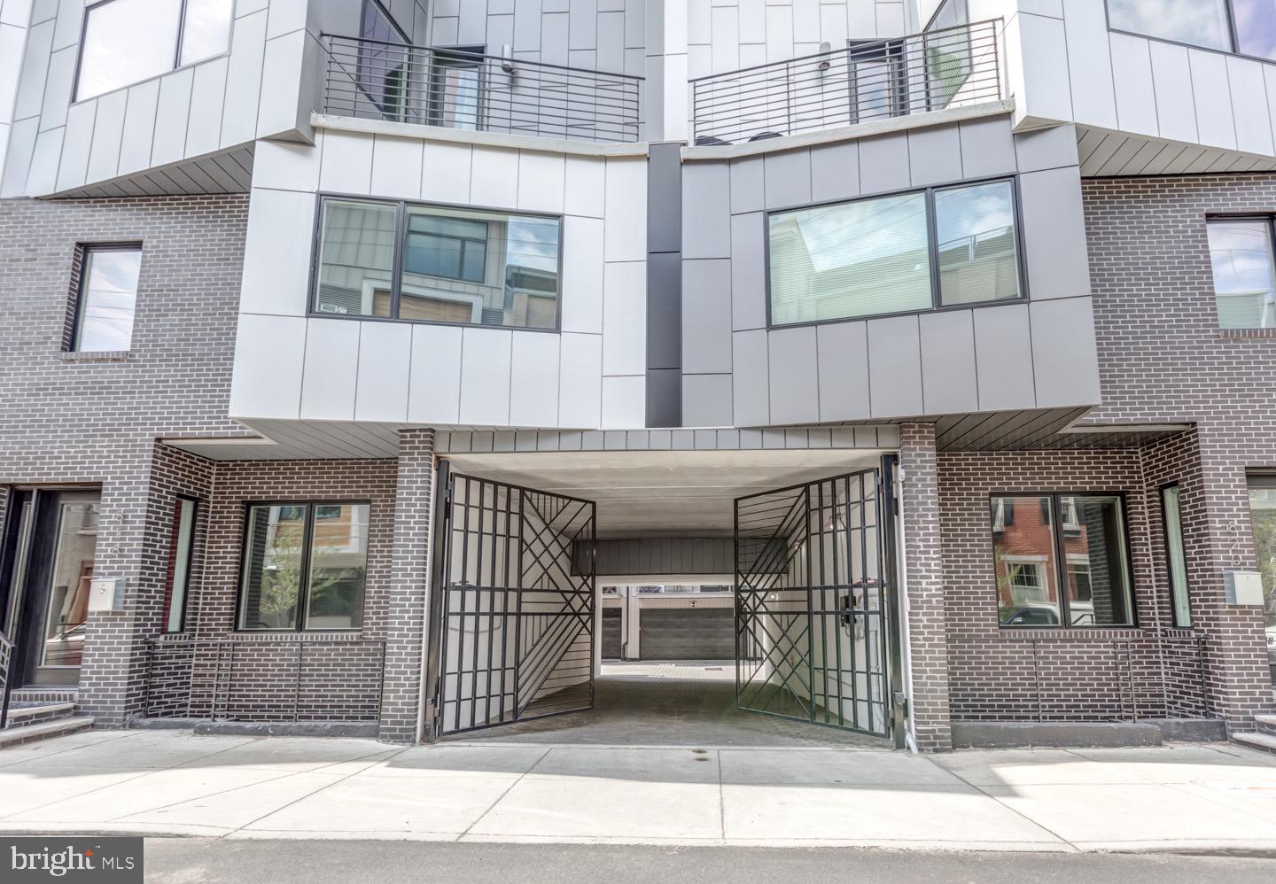 This is a very rare opportunity to own a truly unique home in the heart of Northern Liberties, spanning  nearly 3300 sq.ft townhome is tucked away on a historic cobblestone carriage street leading you to the front door is one of just a handful of homes developed in a gated community within Northern Liberties. An exclusive enclave of seventeen towns homes with oversized two car garages is nestled on a rare garden block. Upon entering through the custom designed automated gates on Lawerence street the drive leads you to a motor court where you will find homes of smooth graphite brick, aluminum composite clad facades, vegetated roofs and multiple outdoor spaces of outfitted with Trex decking. Wide planked wood flooring  flows throughout this home which boasts 3 spacious, private, sunlit bedrooms all en-suite which are outfitted with Porcelanosa vanities, Grohe fixtures, and Toto toilets. With an open concept thoughtfully designed space throughout the home ceiling heights range from 9'-14' including a fully finished lower level including a media room with radiant heated flooring and an additional unique and expansive bonus/ flex space adjacent that could be used for a gym, home office, play room and includes multiple enormous storage closets. The home is tightly insulated with Pella Architect Series windows and doors .  Hand crafted steel stair railings and floating staircases with custom treads that were sourced and reclaimed from a Western Pennsylvania pole barn made with the utmost attention to detail. Atop this gracious home sits the pilot house with a custom built in Poggenpohl wet bar with a stunning quartz counter top that is perfectly suited to supply outdoor entertaining or relaxation on the roof deck while over looking everything from 500 Walnut to Center City skyline including Ben Franklin himself, across the best view of Fairmount for fireworks throughout the year and the golden glimmering dome of St Nicholas. The entire home is efficiently and comfortably lit with 4" recessed LED lighting, there is a built in Sonos sound system with  speakers built into the ceilings of every room throughout all levels of the house and on the roof deck which also has an automated sun setter awning as well. A comprehensive security system with outdoor cameras, multiple receivers inside the home that run a video security communication intercom system and Nest thermostats controlling the dual zone high efficiency Lennox air conditioning and heating all monitor the home for your peace of mind and comfort. A copious array of Poggenpohl kitchen cabinetry line the kitchen walls with Thermador Professional appliances , luxurious quartz counter-tops and custom glass infused  backsplash all surrounding a 9 foot  center island to prep dinner, work on or simply gather around with friends and family. While the home provides an abundance of privacy it is extremely conducive for entertaining as well with split the split floor plan design. The association fee covers common area insurance, lighting and maintenance and snow removal. This unique home is situated so you are secluded from the sounds and hustle of the City yet has a walk score of 95, perfectly placed just a few minutes walk away from some points of interest and amenities such as Cafe La Maude, Honey's Sit 'n Eat, Federal Donuts, Liberty Lands Park, City Fitness, Yards , Silk City, Multiple community Gardens, notably “Orkney Park” just steps away where one can be completely surrounded by mature, flora and fauna.  Various dog parks and children’s playgrounds, Target,The Fillmore and SugarHouse Casino and the MFL line at Spring Garden. This home is a rare outstanding opportunity to live in a very well maintained luxury community while being surrounded greenery, trees and parks. These homes are very rarely available and are truly unique,  thoughtfully planned while nested within Northern Liberties.