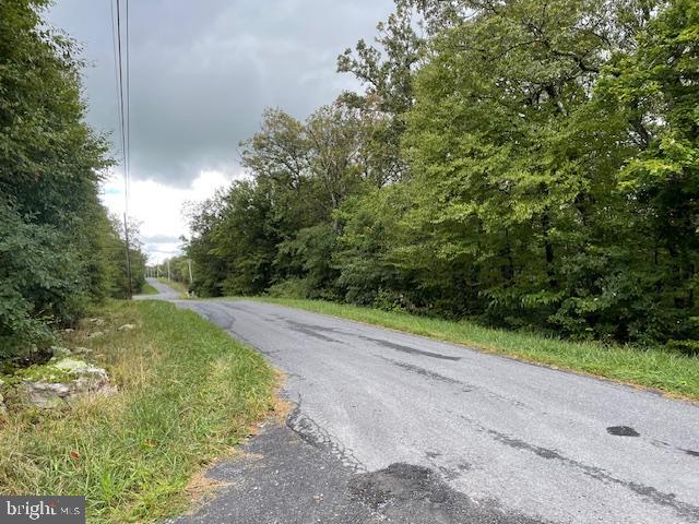 This corner lot in Shawneeland,  a residential community nestled against the backdrop of Great North Mountain. northwestern Frederick County, Virginia, offers the opportunity to return to nature and revel in your privacy.  Build your getaway home or consider moving here permanently.  Enjoy swimming or fishing in the community's spring -fed lake, take the children to the playground, or bring together the family for a long, invigorating hike. 
Shawneeland is only 12 miles from Winchester and its many amenities. Find a large regional medical center there, lots of shopping, restaurants, wineries, breweries, and museums, as well as hiking and biking paths. Winchester, a Tree City USA, is also home to the Shenandoah Apple Blossom festival, a crowd-pleasing week-long party celebrating its 98th year in May 2025.
Shawneeland is located in a Sanitary District. Fee is 190.00 per year for unimproved lots.