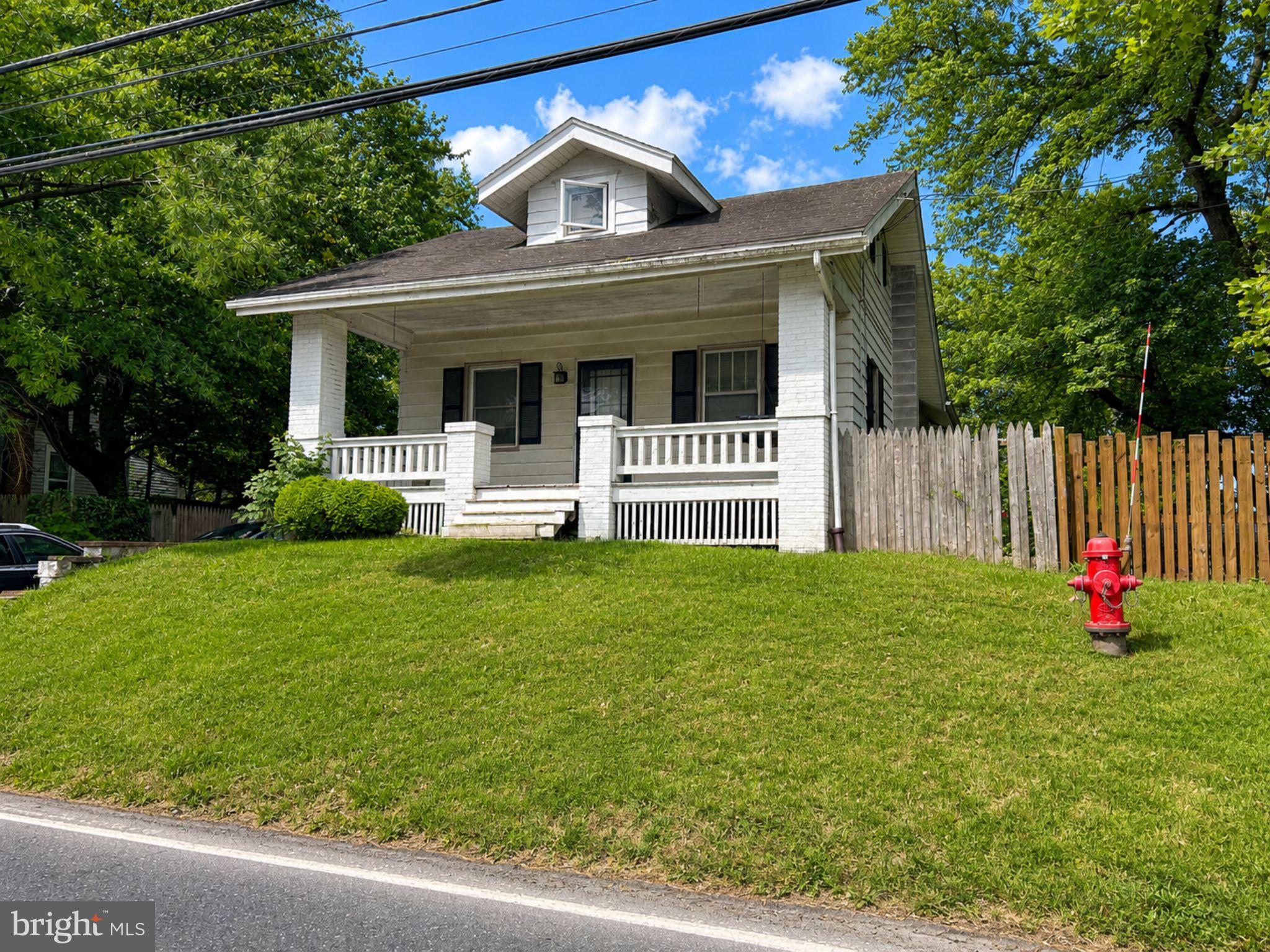 Welcome to this charming bungalow that blends timeless character with everyday comfort. From the moment you arrive, you'll appreciate the inviting covered front porch—perfect for enjoying your morning coffee or unwinding after a long day. Park in the driveway or open the gates to access the extended driveway area, providing additional parking and flexibility.

Step inside to find a welcoming layout featuring a spacious living room, dining area, and kitchen that seamlessly flow together, creating an ideal space for entertaining guests or everyday living. The main floor also offers two bedrooms and a full bathroom. Upstairs, you'll find an additional bedroom that offers flexibility for a variety of uses, including a home office, hobby room, or recreational area. 

The basement, attic, and outbuildings provide abundant storage space, offering plenty of room for seasonal items, tools, and everyday belongings. Outside, the spacious fenced backyard provides the perfect setting for outdoor gatherings, barbecues, gardening, pets, or simply relaxing and enjoying the outdoors.

Conveniently located near shopping, dining, parks, and major commuter routes, this home offers a wonderful blend of character, functionality, and value.