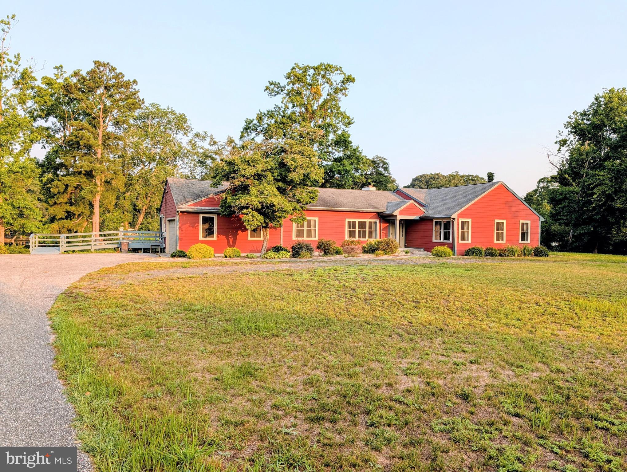 Welcome to waterfront living on beautiful Williams Pond! Nestled on a private 0.72-acre lot, this beautifully updated custom ranch offers over 2,700 square feet of thoughtfully designed one-level living with peaceful water views from nearly every room. Remodeled in 2014, this exceptional home features three spacious bedrooms, each with its own private en-suite bathroom, plus an additional half bath for guests. The luxurious primary suite serves as a private retreat with a spa-inspired bath complete with a custom tiled shower, dual vanities, and generous closet space. The updated kitchen is the heart of the home, showcasing granite countertops, a center island, and abundant workspace, while the formal dining room, inviting living room with custom built-ins and a gas fireplace, bright sunroom, and separate sitting room provide plenty of space for entertaining or simply relaxing while taking in the tranquil waterfront setting. Step outside to the cozy deck overlooking the pond or enjoy direct access to navigable Williams Pond, perfect for kayaking, canoeing, fishing, or peaceful boat rides. Additional highlights include beautiful cherry bamboo flooring, main-level laundry, an attached side-entry garage, an outbuilding for extra storage, a newer septic system, and numerous accessibility features, including wide hallways and doorways, ramp access, grab bars, a roll-under vanity, and a roll-in shower. Combining the beauty of waterfront living with the convenience of one-level living and modern updates, this rare property offers a peaceful retreat just minutes from shopping, dining, and everyday conveniences in Seaford.