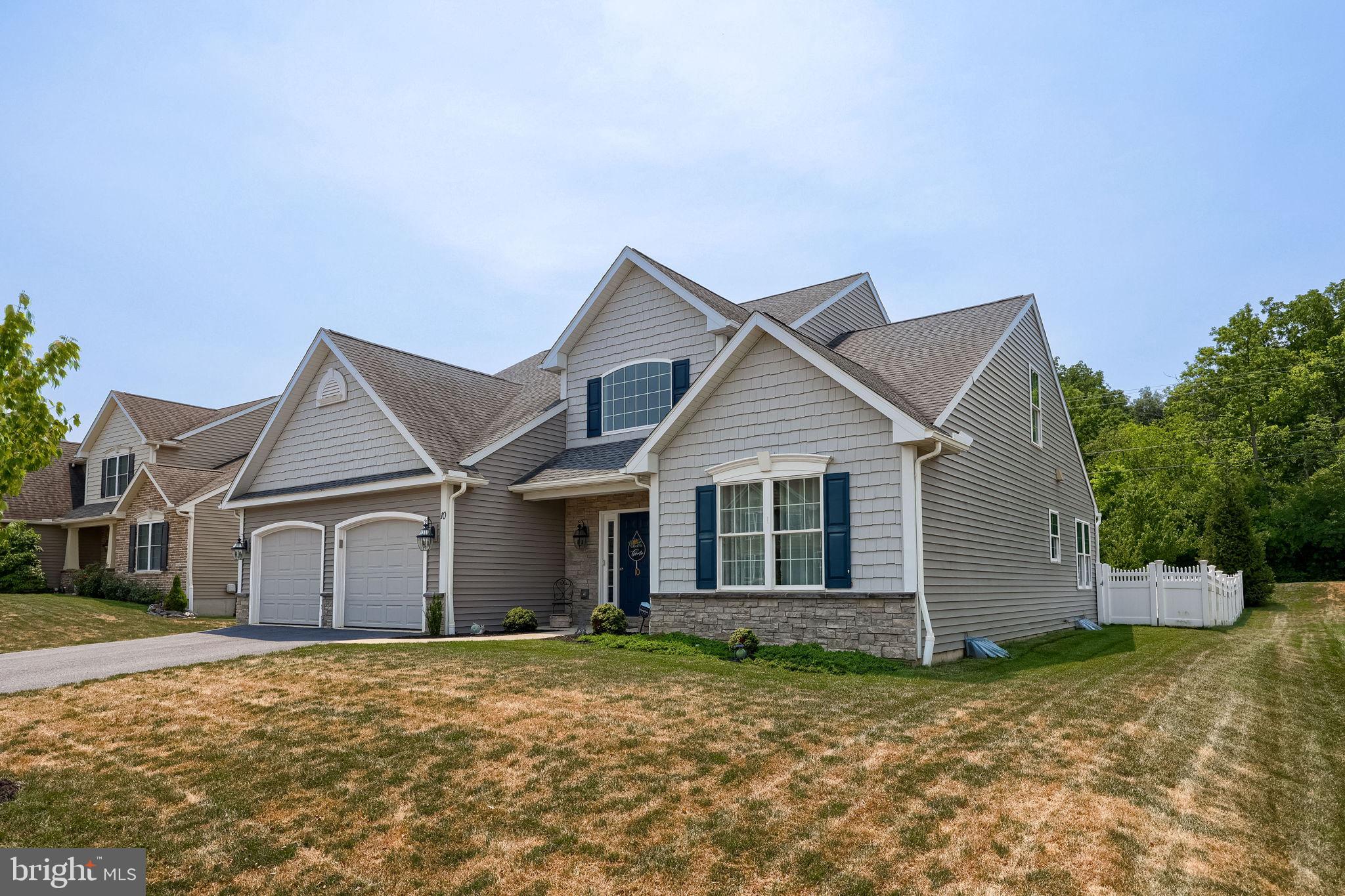 Absolutely immaculate and impeccably maintained, single family home, with primary owner's suite on the main level, within the Green Valley West subdivision, and the ever-popular Wilson School District of Berks County. This home boasts a two-car, front entry garage, with 4 additional driveway parking spaces, a partial stone and vinyl cedar shake facade, with partial stone skirting, and a fully fenced and private rear yard, with a concrete patio, and side entry Bilco doors, for access to the unfinished full basement. You are welcomes into the home through the bright, two-story entry foyer, with neutral ceramic tile flooring, a convenient powder room, and a spacious dining room with hardwood flooring, arched entry way, and tray ceiling accented with bright white chair rail and crown molding. The gourmet kitchen is spacious and open to the breakfast room with sliders to the rear patio, 18" neutral ceramic tile flooring, dark stained and crown molded maple cabinetry with beautiful granite counter tops and back splash, gas cooking, full pantry, recessed end pendant lighting over the peninsular breakfast bar with stools, and an undermounted stainless steel sink. All kitchen appliances will remain. All window blinds and curtains throughout the home will remain as well. The kitchen and breakfast room are open and flow beautifully into the vaulted living room, with corner, natural gas fireplace with marble surround, a wall of windows with transom windows above, ceiling fan and recessed lighting. The primary owner's suite is conveniently located on the main floor, adjacent to the family room, and will become your private oasis at home! The bedroom has neutral decor and carpeting and has ample floor space for even the largest of bedroom suits. There is a generously sized walk-in closet and a super bath, with neutral ceramic tile flooring, a double vanity and twin sinks, and an incredible marble, granite, and tiled, walk-in shower, with an overhead, rain-style shower head, with an additional wall mounted shower head with a handheld spray head, and a convenient shower seat, with half inch thick glass shower doors. The laundry room is conveniently located on the main level as well, on your way out to the two-car garage. Heading upstairs, the staircase is stained wood with a neutral carpeted runner, and stained handrail with basket style wrought iron spindles. The upstairs landing is open to the family room and foyer below, and leads to two very nicely sized bedrooms, and a shared family bath with a shower tub combination. This home's basement is large, dry, and could be easily finished for additional recreational or living space with a set of Bilco doors on the left side, leading up to grade. The rear yard is also large enough for a future pool. This home is ready for a quick settlement and is close to all roadways and conveniences that makes Lower Heidelberg Township and the Wilson School District so popular.