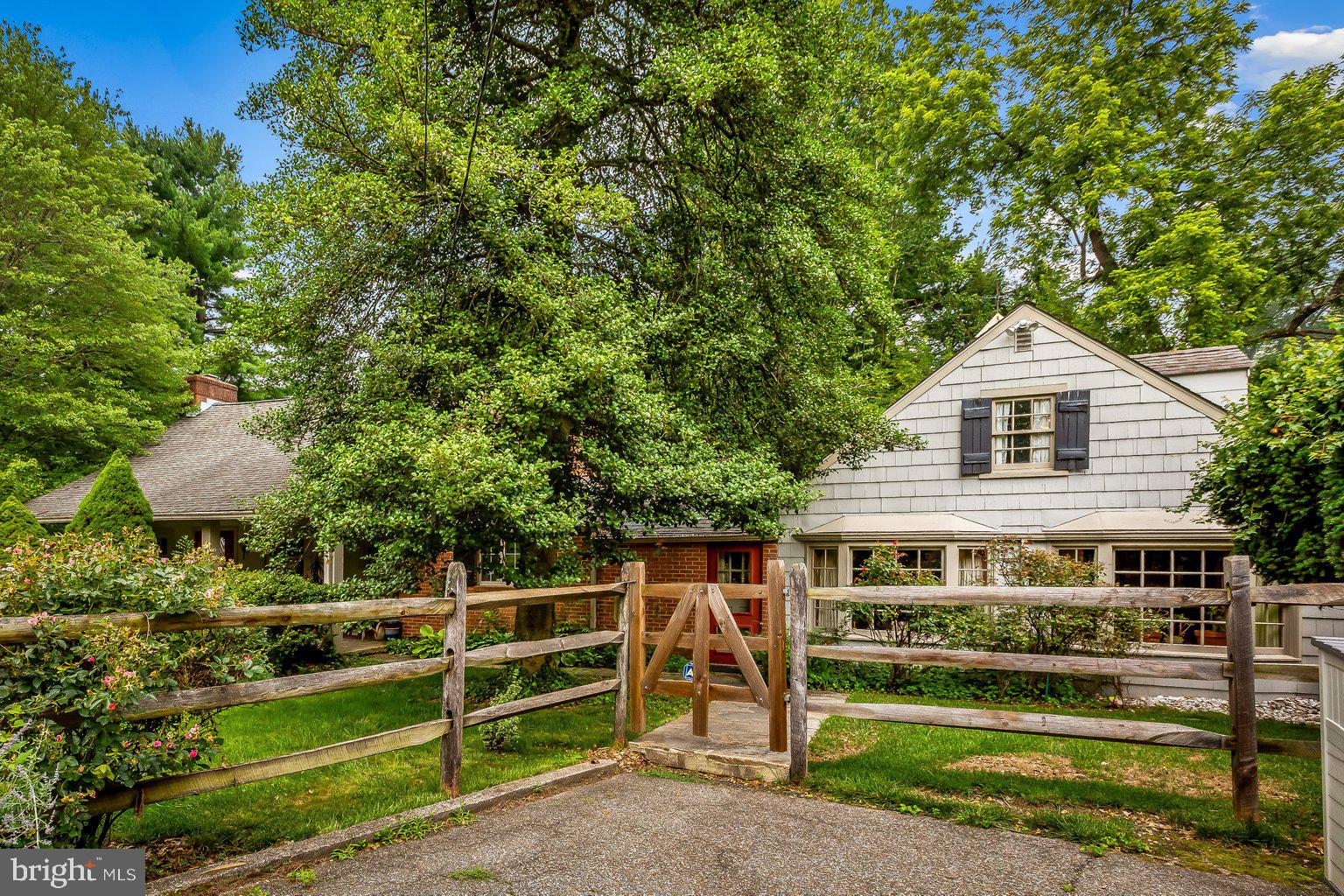Come view this cozy cottage situated on a beautifully landscaped 1.14 acre corner lot in the heart of Ruxton. This cottage has two (2) distinct wings that are connected by a galley kitchen. The 1st floor of the West wing consists of a Great Room w/ a 17' high vaulted ceiling with pine planking, built-in bookcases, 3 skylights and a raised hearth brick fireplace that will require some repair. A dining area + a bedroom (Currently used as an office) and powder room are adjacent to this space --- The 22' Primary bedroom is also on the 1st level and has pegged flooring, a vaulted ceiling, built-in cabinets, 2 closets and a wood burning fireplace that will require some repair --- The bath that serves the Primary bedroom has a tub/shower combination, large linen closet & recessed lighting. On the 2nd floor of the West wing is a catwalk leading to a 17' bedroom w/ a skylight, pine flooring & a half bath. The 21' galley kitchen has granite countertops, pine planking and an assortment of appliances w/ access to the oversized flagstone courtyard. The 1st floor of the East wing consists of a 19' family room w/ 2 bay windows, a ventless gas fireplace and access to a 2nd full bath w/ a tiled, tub & shower combination. A 4th 19' bedroom is on the 2nd level w/ pine planks, a skylight & built-in shelves. The property is serviced by public water and a private septic system --- When you arrive at the house you will see straw covering part of the property - That is the area where NEW drain fields have just been installed --- Relax on the covered front porch or the flagstone courtyard --- A driveway provides ample parking for 2 cars. The seller is selling this property "AS-IS" --- Any and all inspections are welcomed.