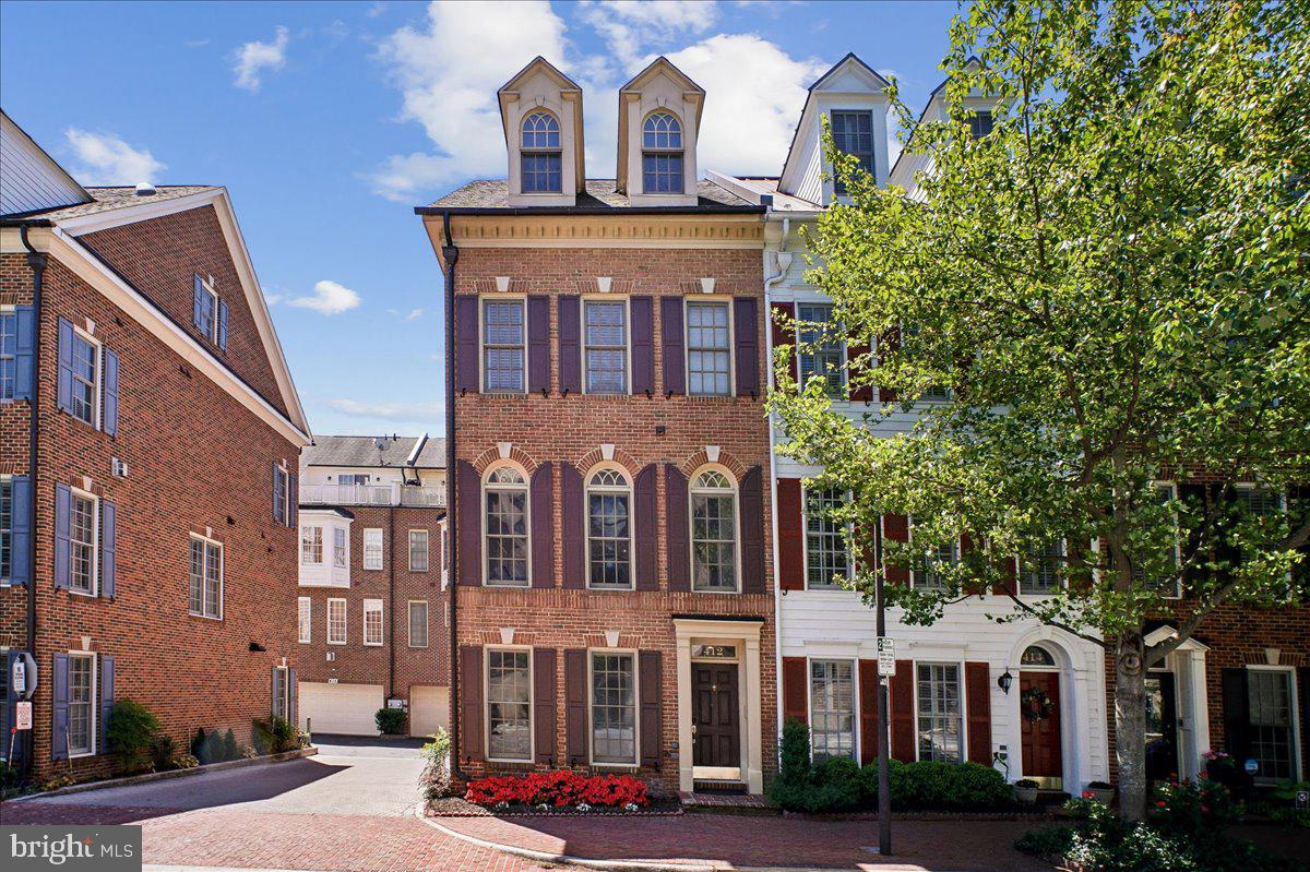 A rare four-level brick end-unit townhome in one of Old Town Alexandria’s most desirable locations. Ideally positioned between the established charm of historic Old Town and the continued evolution of Old Town North, you are mere steps away from restaurants, shops, parks, playgrounds, King Street, the Metro, and the Potomac waterfront.

With 3 bedrooms, 3.5 baths, and a two-car garage, this home offers the space, natural light, and convenience buyers rarely find together in Old Town. The entry level includes a private office with French doors, ideal for work-from-home flexibility, plus direct garage access. The sun-filled main level is framed by Palladian windows, high ceilings, crown molding, hardwood floors, and a gas fireplace with custom built-ins. The open layout flows easily from living and dining areas to a standout kitchen with a large island, gas cooking, abundant cabinetry, and a dedicated coffee bar.

Upstairs, the primary suite features a bay window, expansive customized walk-in closet, and spa-like bath with double vanity and separate shower. A second bedroom, full hall bath, and laundry complete this level. The top floor adds a private third bedroom with en-suite bath, an additional flex living area, and access to a rooftop deck for relaxing, entertaining, and enjoying fresh air above the neighborhood.

Per ACPS redistricting notifications, this address is slated for Lyles-Crouch Elementary as of the 2026–27 school year.