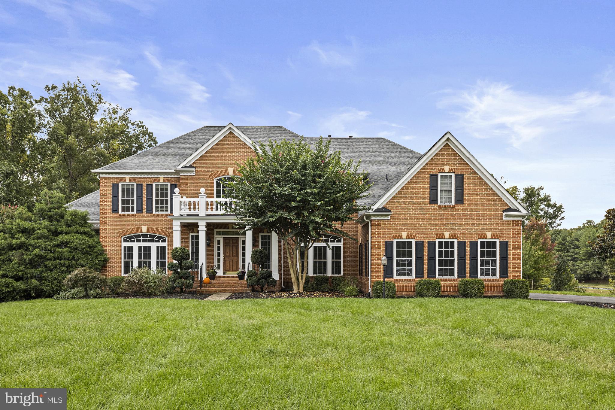 Welcome to this stunning estate in Great Falls, a masterpiece of luxury living built in 2003 and located on a quiet cul-de-sac off Seneca Rd.  Spanning an impressive 8,000 square feet across three spacious levels, this home perfectly blends elegance and functionality.  Upon entering, you are greeted by a soaring two-story foyer with dual staircase that sets the tone for the grandeur found throughout. The expansive great room features stunning views and abundant natural light from floor to ceiling windows and a cozy ambiance, complemented by one of the home's three fireplaces. The gourmet kitchen is a chef's dream, equipped with top-of-the-line appliances, including a sparkling beverage fridge, ample counter space, and an adjoining sunroom that overlooks the serene and private surroundings.  Dedicated office space offers built in shelving and a beautiful solarium provides tranquil spaces to enjoy the outdoors year-round.  This exquisite residence boasts five well-appointed bedrooms, each offering its own ensuite bathroom. The primary suite is a true retreat, featuring a private sitting room with fireplace, perfect for relaxation. 
The lower level is designed for both comfort and entertainment, featuring a walkout design, a second kitchen, an additional bedroom,  a full bathroom—ideal for guests or an in-law suite--plus plenty of unfinished space for extra storage.
Set on nearly 2 acres within a peaceful cul-de-sac, the property features a flat backyard perfect for outdoor activities and gatherings. The home also includes a spacious three-car garage, providing additional storage and convenience.  MULTIPLE UPDATES in the last 3 years, including roof, HVAC, fresh neutral paint throught and most appliances.  This remarkable estate is not just a home; it's a lifestyle. Don’t miss the opportunity to make it yours!