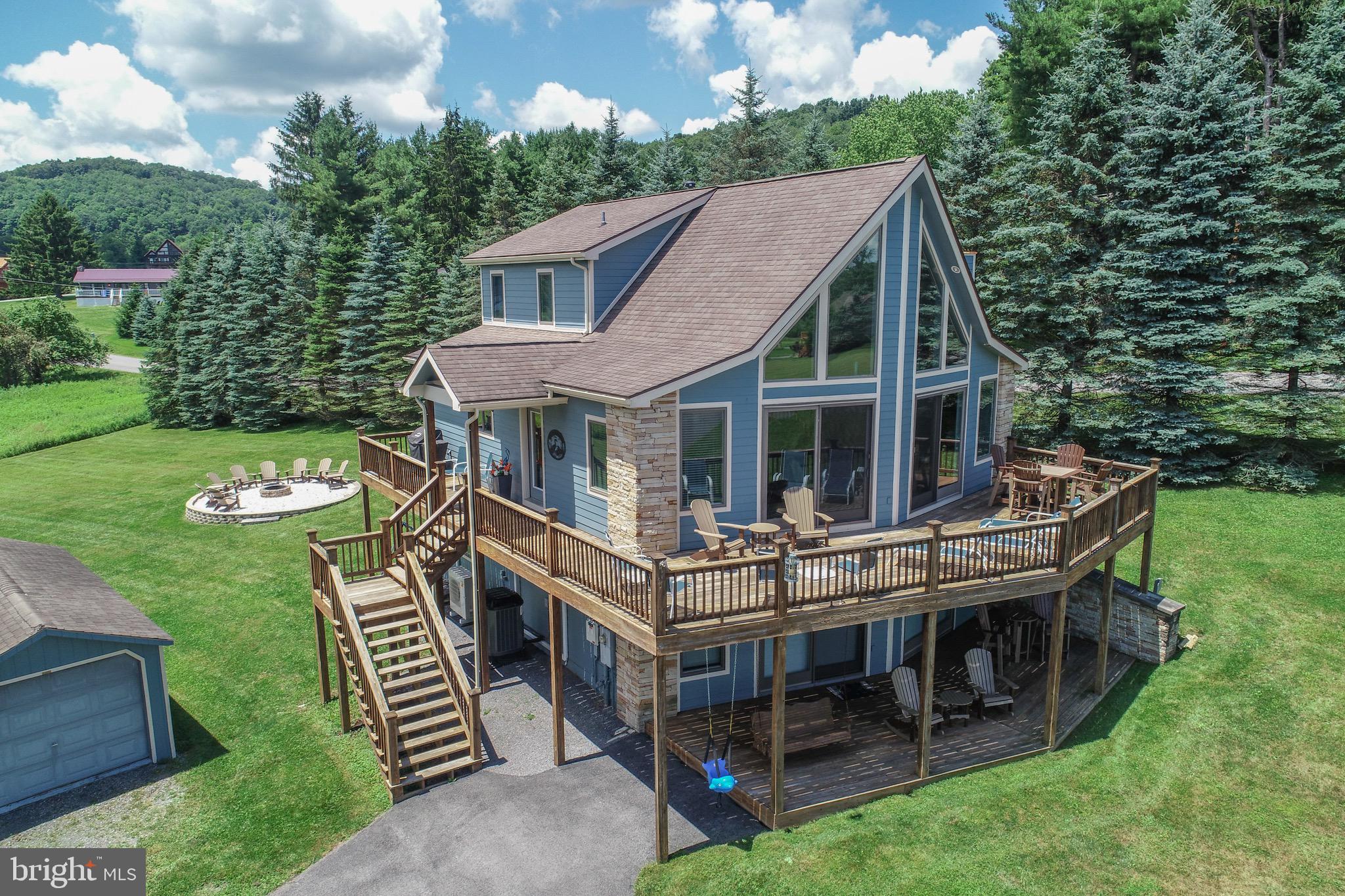 Welcome to your perfect Deep Creek Lake retreat—where lake and mountain views, modern comforts, and year-round recreation come together. This beautifully maintained 4-bedroom, 3 full bath home offers nearby lake access with a full-time boat slip, making it ideal for both relaxation and adventure!
The main level is filled with natural light thanks to an abundance of windows and doors, highlighting the spacious open floor plan. The inviting living room features a stunning stone fireplace and flows seamlessly onto a large deck facing the lake—perfect for entertaining or unwinding at sunset. The kitchen is equipped with upgraded countertops, newer stainless steel appliances, and the entire level is complemented by newer luxury rustic flooring throughout. You’ll also find a convenient laundry room with pantry storage and a main-level bedroom with full bath.
Upstairs, the expansive primary suite offers a private bath and a peaceful escape. The lower level is designed for fun and functionality, featuring a large family/recreation room complete with a pool table and wet bar, two additional bedrooms, and another full bath. Step outside to the lower  porch and enjoy the spacious yard spaces, including a newer professionally landscaped fire pit area in the back yard that creates the perfect setting for memorable evenings under the stars.
Recent upgrades include newer siding, HVAC system, hot water tank, and water conditioning equipment, along with two high-efficiency heat pump air handlers serving the lower level for added comfort and zone control—offering peace of mind for years to come. The paved driveway and large storage shed add to the home’s practicality.
Located in the desirable Heron Cove community with paved roads, tennis court, and scenic walking trails through protected wooded common areas, you’ll also enjoy access to a nearby lakefront community beach area in a quiet no-wake cove—ideal for easily docking your boat, swimming and paddle boarding. A great added convenience for buyers: the sellers are willing to leave the golf cart with the property, and the neighborhood permits golf cart parking in the designated area near the docks. This is a wonderful feature for families with boats or children enjoying the beach area, making trips between the home and the lake easy and hassle-free without concern about the distance.
All of this in a central Deep Creek Lake location, just minutes from local restaurants, marinas, shops, and Wisp Ski Resort. Whether you’re seeking a vacation home, or investment property, this lake-area gem has it all.