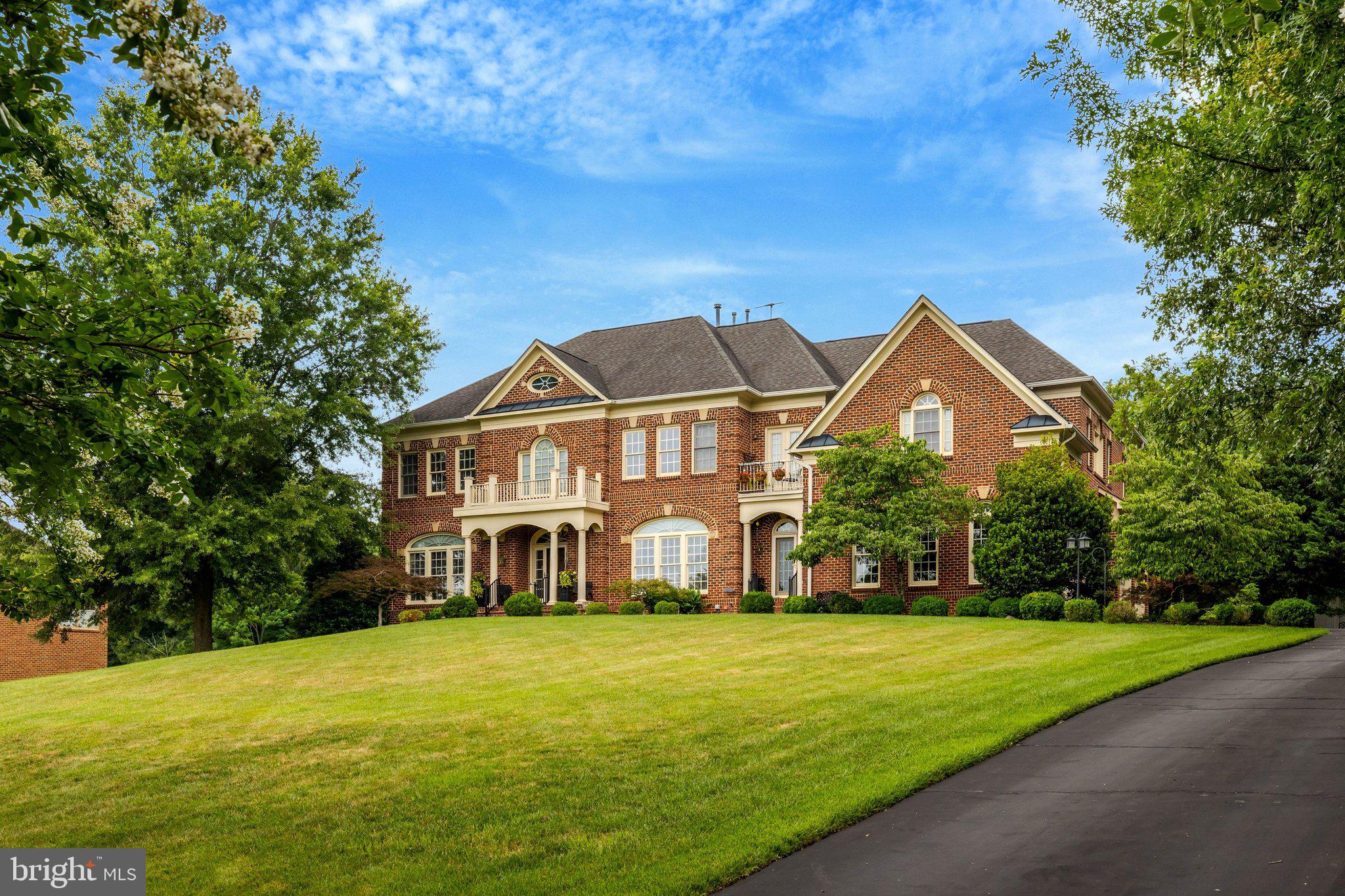 Welcome to 11042 Heathland Drive, an extraordinary Renaissance Homes Grand Michelangelo estate in one of Oakton's most prestigious and private neighborhoods. Set on a beautifully landscaped .88-acre homesite near the end of a quiet cul-de-sac, this stately all-brick residence offers over 9,300 square feet across three finished levels with 6 bedrooms, 6 full baths, 2 half baths, and an exceptional floor plan designed for elegant entertaining, executive living, and multigenerational flexibility.

A grand approach, framed by brick entry columns, a sweeping front lawn, and a slate walkway, leads to an impressive portico entrance. Inside, a dramatic two-story foyer welcomes you with soaring ceilings, a sweeping curved staircase, gallery-style architecture, oversized windows, and striking sightlines that establish the home's timeless elegance.

The main level balances formal sophistication with everyday comfort. Formal living and dining rooms, complemented by a butler's pantry, create the perfect setting for memorable gatherings, while a richly appointed executive study with custom built-ins provides an ideal work-from-home environment. The spectacular 21' x 30' family room features a coffered ceiling and walls of windows that flood the home with natural light.

At the heart of the residence is a gourmet chef's kitchen designed for entertaining and daily living alike. An oversized granite island anchors the space, accompanied by a 6-burner gas cooktop, KitchenAid double wall ovens, JennAir refrigerator, walk-in pantry, abundant custom cabinetry, expansive prep space, and bar seating. The adjoining breakfast area and keeping room create a warm gathering space, while a secondary staircase provides convenient access to the upper level.

Beyond the kitchen are the mudroom, spacious laundry room, second powder room, and one of the home's most distinctive features: an oversized four-car garage with four individual bays, including a hydraulic vehicle lift—an exceptional amenity for automobile enthusiasts, collectors, hobbyists, or additional storage flexibility.

The upper level offers remarkable privacy, with four generously sized secondary bedrooms, each featuring its own en-suite bath. An elevated loft provides additional flexible living space for reading, studying, or relaxing. The luxurious primary suite serves as a true owner's retreat, complete with a spacious sitting room, Juliet balcony, three walk-in closets, and a spa-inspired bath featuring an oversized walk-in shower, jetted soaking tub, dual vanities, and separate water closets. A private rear staircase connects the primary suite to an additional 5th en-suite bedroom, making it ideal for multigenerational living, an au pair suite, extended guests, or a second private office.

The fully finished walk-out lower level expands the home's versatility with an expansive recreation room, billiards area, game room, fitness studio easily convertible to a private theater or media room, 6th legal bedroom, full bath, generous storage, and direct access to the backyard.

The boutique Heathland community consists of approximately two dozen estate homes, many built by Renaissance Homes, creating an established neighborhood known for its spacious homesites, mature landscaping, and enduring architectural appeal. Residents enjoy a rare combination of peaceful surroundings and exceptional convenience.

Located just minutes from Routes 66, 50, 123, and 29, the home offers effortless access to Vienna Metro, Tysons, Fairfax, the Capital Beltway, Washington, D.C., Dulles International Airport, and Reagan National Airport. Premier shopping, dining, parks, recreation, and everyday conveniences—including Wegmans, Costco, Home Depot, and numerous retail destinations—are all just minutes away.

Offering grand-scale entertaining spaces, exceptional craftsmanship, a highly functional floor plan, executive-level amenities, and one of Northern Virginia's most desirable locations, this one won't last!