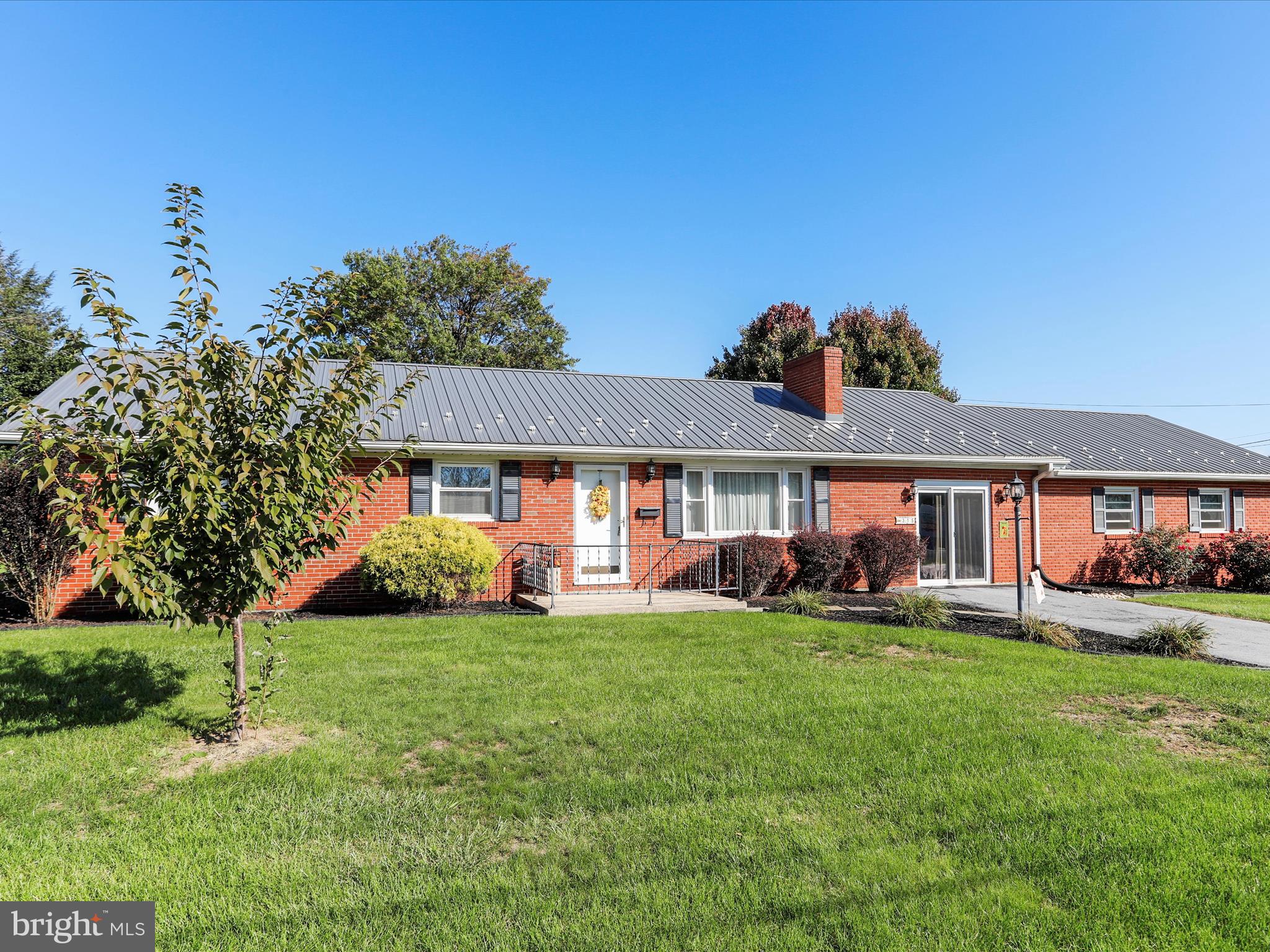 Very well kept 3 bedroom 1 full bath all brick rancher that is located on a double corner lot.  This property has a large family room with woodburning fireplace and a second family rm on the main level that leads out to an enclosed back patio. There is a finished room in the basement which also has a woodburning fireplace.  New metal roof installed 2 years ago. Brand new heat pump system with some rooms having electric BB backup heat.  2 car garage with attic access and an unfinished basement for storage or future living space.