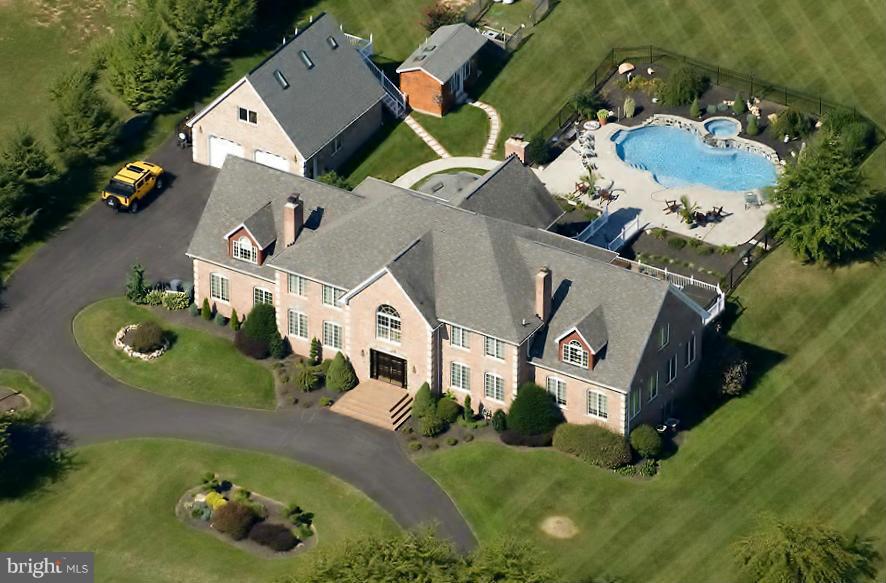 Extraordinary custom manor on 3 acres, w/ grand foyer w/marble floors; FR w/2-story ceiling & balcony overlook; Chefs KIT w/granite ctrs; Sunroom w/walk-out to rear & det. garage w/prvt. Au Pair suite. LL wet bar; MBD w/sitting Rm, prvt balcony, gas FP & luxury BA. Exquisite moldings, accents, paints & fixtures; ML LIB & Fitness Rm. Backyard paradise w/heated pool, spa and cabana. By appt only.