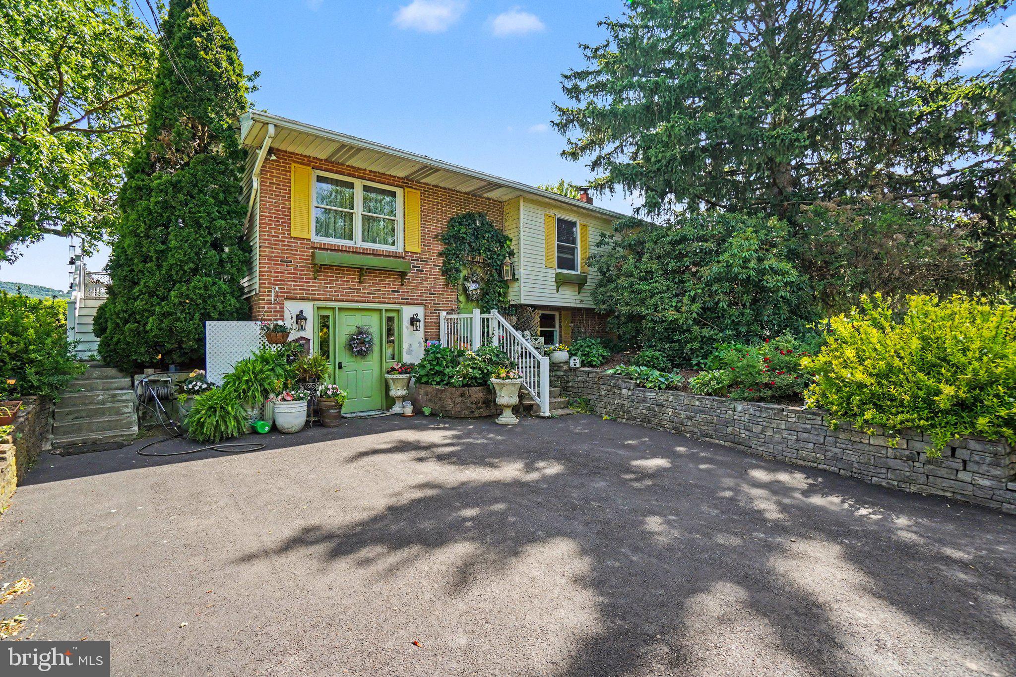 Welcome to this beautifully landscaped 5-bedroom, 3.5-bath home offering space, comfort, and versatility for the whole family! Step inside to a welcoming living room and a completely renovated eat-in kitchen, perfect for everyday living and entertaining. The dining area provides a warm gathering space for family meals and special occasions.

The fully finished lower level offers incredible flexibility and functions much like a private apartment. It features a cozy living room with a pellet stove fireplace, a separate eat-in kitchen, office space, washer and dryer hookups, a full bathroom with a walk-in shower, and its own separate electric meter—making it ideal for extended family, guests, or a variety of living arrangements.

Enjoy the outdoors from multiple covered and open porches, providing plenty of space to relax and take in the beautiful surroundings. The oversized attached two-bay garage includes a convenient half bath and ample storage space.

Outside, you'll find a spacious patio area with a fireplace, an above-ground pool, and multiple storage sheds, creating the perfect setting for entertaining, hobbies, and outdoor enjoyment.

This property truly has it all—space, functionality, and endless amenities. Schedule your private showing today!