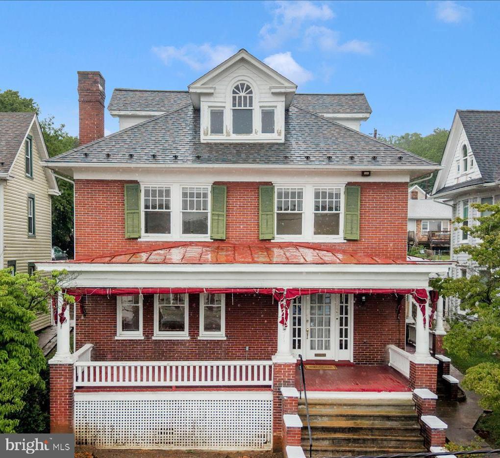 Don't miss your opportunity to restore this one-of-a-kind all-brick Brunswick Masterpiece back to it's former glory!  Experience the majestic feel of this home with its large rooms and high ceilings throughout.  Enjoy the hometown feel as you spend cool evenings on the massive front porch 29 x 10 1/2.  Enter through the front door to a spacious foyer and hardwood floors throughout.  The living room and dining room have large windows that brighten the space.  The kitchen comes with a custom breakfast nook, pantry, and its own broom closet.  The kitchen walks out to a large rear flagstone patio that allows plenty of space for outdoor dining and grilling.  This home features four oversized bedrooms with scenic views on upper levels and built in shelving for an extra storage closet in the foyer on the bedroom level.  Above the bedroom level is a huge walk-in third level attic which has endless possibilities for future expansion.  This home is loaded with original custom features such as pocket doors, 9 ft ceilings, transom windows, original brass and glass hardware, kitchen broom closet and extra storage between main level and bedroom level.  The basement is a large spacious area with loads of potential for a recreation room, workout space, game room, theater room, studio, a place just waiting for your creative custom features.   The backyard has a cast iron fence and private parking with a two-space paver driveway.  New architectural 35 yr+ shingles were installed in 2018. This home is impressive with its all-brick solid construction. It is waiting for someone who can add their personal touches and updates.  Close to commuter routes, MARC, C&O Canal, library and downtown shopping.