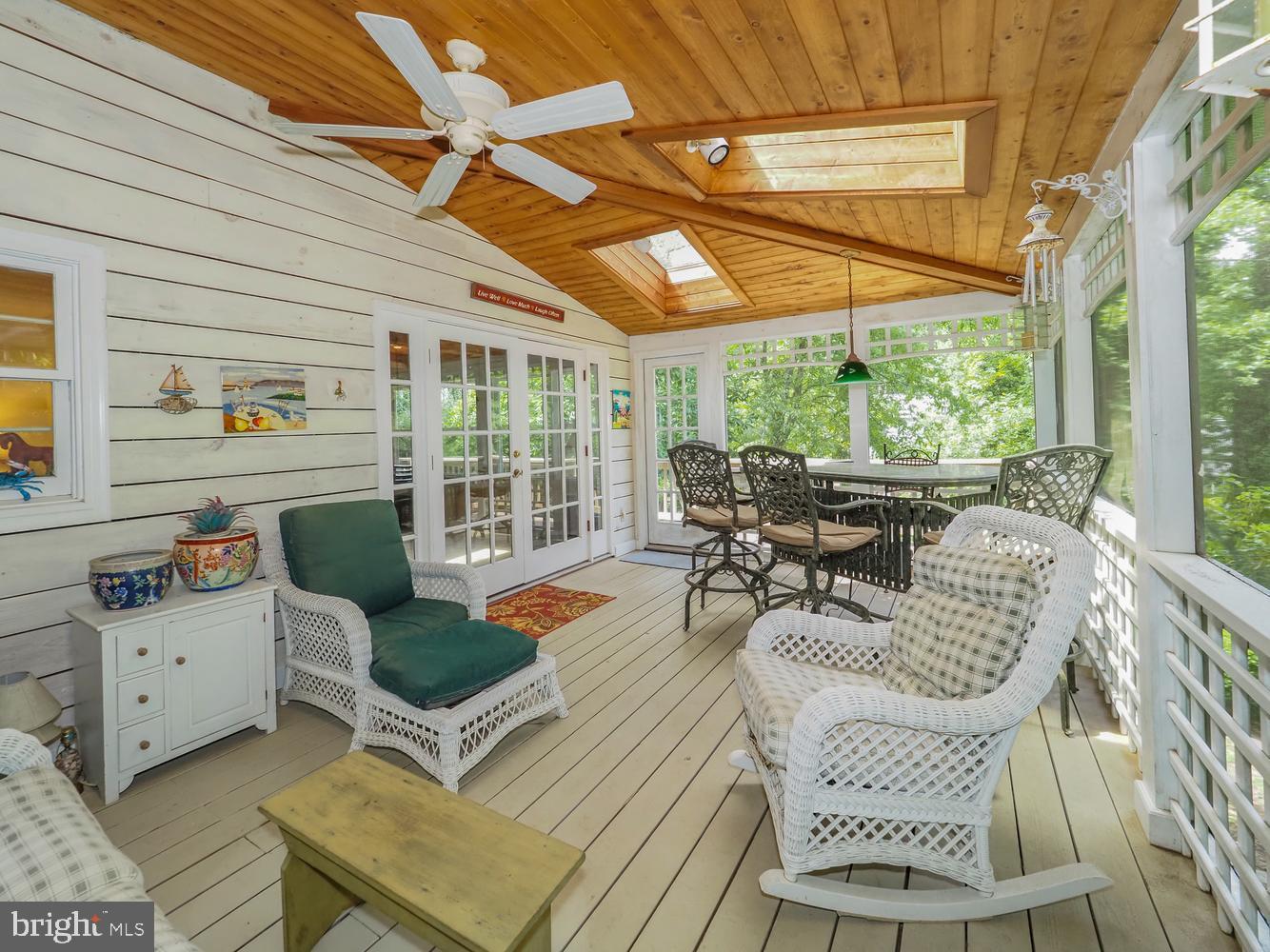 The sellers are offering $10,000.00 towards purchasers closing costs!
Enjoy the water privileged lifestyle of the Annapolis Roads community on Lake Ogleton, Annapolis. This distinctive home offers an abundance of custom features,  indoor and outdoor living spaces, great views, architectural details, and access to some of Annapolis' most sought-after waterfront amenities. From the beautiful  screened porch / family room, to the covered deck, ivy covered brick walled patio, and sun room, there are many special areas to relax or entertain.
The large number of windows and double doors provide natural light and amazing air flow throughout. The sunroom is a standout feature, showcasing hand-hewn beams, custom cabinetry, and a wall of  New England-style windows that fill the space with natural light, and, of course, fresh air.
Custom lighting throughout the home highlights the crown moulding, built-in shelving, cabinetry, and workspaces. The spacious primary suite features an ensuite bath with a jetted tub, walk-in closet, and an additional shoe closet. A second jetted tub is located in the upper-level hall bath.
Extensive landscaping surrounds the property, creating multiple inviting outdoor spaces. 
Major systems and appliances recently updated include the furnace (3 years), dishwasher, two air conditioning units( approximately 9 years), washer and dryer. Updated windows.
Residents enjoy access to Annapolis Roads' exceptional amenities, including a boat ramp, private beach, bayfront pavilion, bayside picnic area, playground, fire pit, community pier, kayak/SUP storage, extensive hiking trails, and a variety of neighborhood events throughout the year.
Drop your boat in and visit the Annapolis Historic District by water; something very  
few neighborhoods offer.
A unique opportunity to enjoy the waterfront lifestyle, charm, character, and community spirit that make Annapolis Roads such a special place to call home.