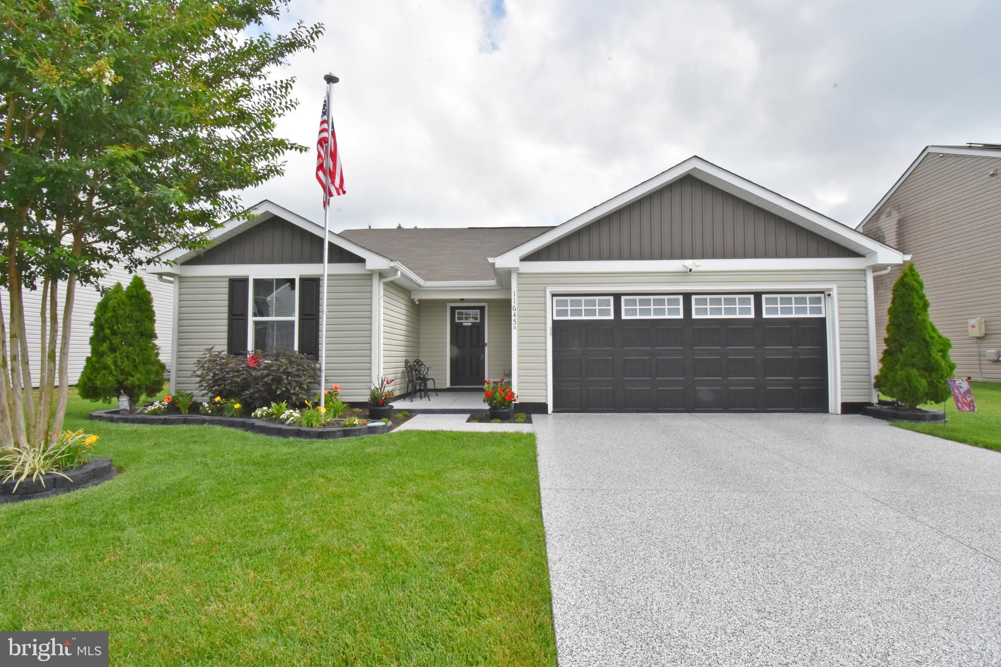 Welcome to 11645 Buckingham Drive in the highly desirable Yorkshire Estates community, conveniently located just over the Delaware/Maryland line in Delmar, DE. This beautifully maintained 3-bedroom, 2-bathroom home offers 1,292 square feet of thoughtfully designed living space with an open-concept layout that's perfect for both everyday living and entertaining. The spacious kitchen flows seamlessly into the living and dining areas and features matching stainless-steel appliances for a clean, modern look. Step outside to enjoy the meticulously landscaped yard, where colorful flowers are currently in bloom, creating exceptional curb appeal. Keeping the lawn lush is effortless with the 4-zone in-ground irrigation system, conveniently controlled right from your smartphone. No detail has been overlooked—every exterior hard surface, including the garage floor, has been professionally epoxied for lasting durability and a polished finish. The backyard is ready for relaxation, with patio furniture that conveys with the sale, allowing you to enjoy your outdoor space from day one. Additional highlights include a spacious garage with a large workbench, a flagpole nestled within the front flower bed, and a location that offers the perfect balance of peaceful neighborhood living with easy access to both Delaware and Maryland amenities. This move-in-ready home has been lovingly cared for and is ready to welcome its next owners. Schedule your private showing today!