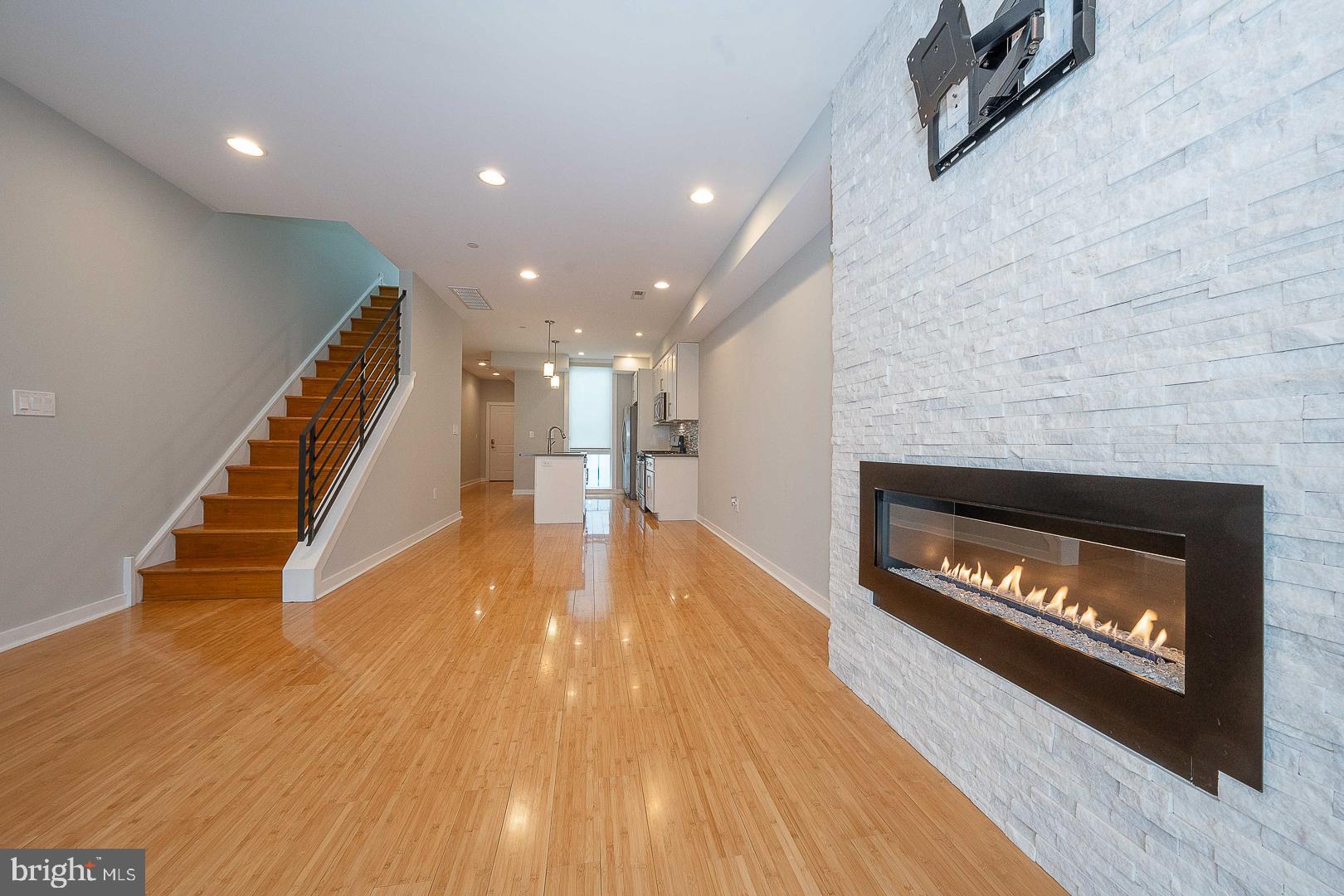 Great location just steps to Fairmount Ave with Low Condo Fees, a Private Roof Deck, Fireplace and an assigned garaged Parking Space paid by the seller through January 2027!  What more can you want in a Francisville Condo?  This Bi-Level Unit, built in 2015 packs a lot into a well designed floor plan.  The Hallway opens into the Main Level. You first notice the large Kitchen with a Island that can seat 4.  There's plenty of cabinets for storage.  Lots of attention was put into details like the Shaker Cabinets, quartz Countertops, Stainless Steel Appliances and Tiled Backsplash. Just beyond the kitchen is ample space for a full sized Dining Area, or you can use some of this space for additional Living Space.  The Open Floor Plan allows fora ton of flexibility.  The Main Living Area offers plenty of Natural Light that flows through the entire Main Level.  There is bamboo hardwood flooring throughout and the 9 foot ceilings enhances  the openness of this space.   It's hard to miss the floor to ceiling white stone accent wall with gas Fireplace that is the focal point of the Living Area.  This entire level is made for entertaining,, but intimate enough for a quiet relaxation.  The Harwood Floors carry through to the Second Floor that has two high ceilinged (8.5Ft) Bedrooms with Closets and more Natural Light. The Second Floor is completed with a Tiled Hall Bath, a large Linen Closet and a Laundry Room with a full sized Washer and Dryer.  No more walking up and down steps with your laundry! The best part of the Second Floor is that it provides access to your Balcony and Private Roof Deck.  A Spiral Staircase transports you to your own space to relax, entertain or just enjoy the outdoors with a spectacular 360 Degree view of the Philadelphia Skyline. When it's time to leave your home, there's no need to remember where you left your car, circle the block to find a space late at night, or find a shovel to dig it out of the snow,  You have an assigned garage Parking Spot!  It's just around the corner and it's rental has been prepaid for you through 2/1/2027.  Condo fees have been paid by seller through December 2026 and will be credited to new owner.  Freshly painted and truly move-in ready, this home offers low condo fees, modern construction, and a walkable location in one of Philadelphia’s fastest-growing neighborhoods. Please check out the video view.  Stay until the end to experience the roof deck  Don't miss the opportunity to have all you need in a great, convenient location.