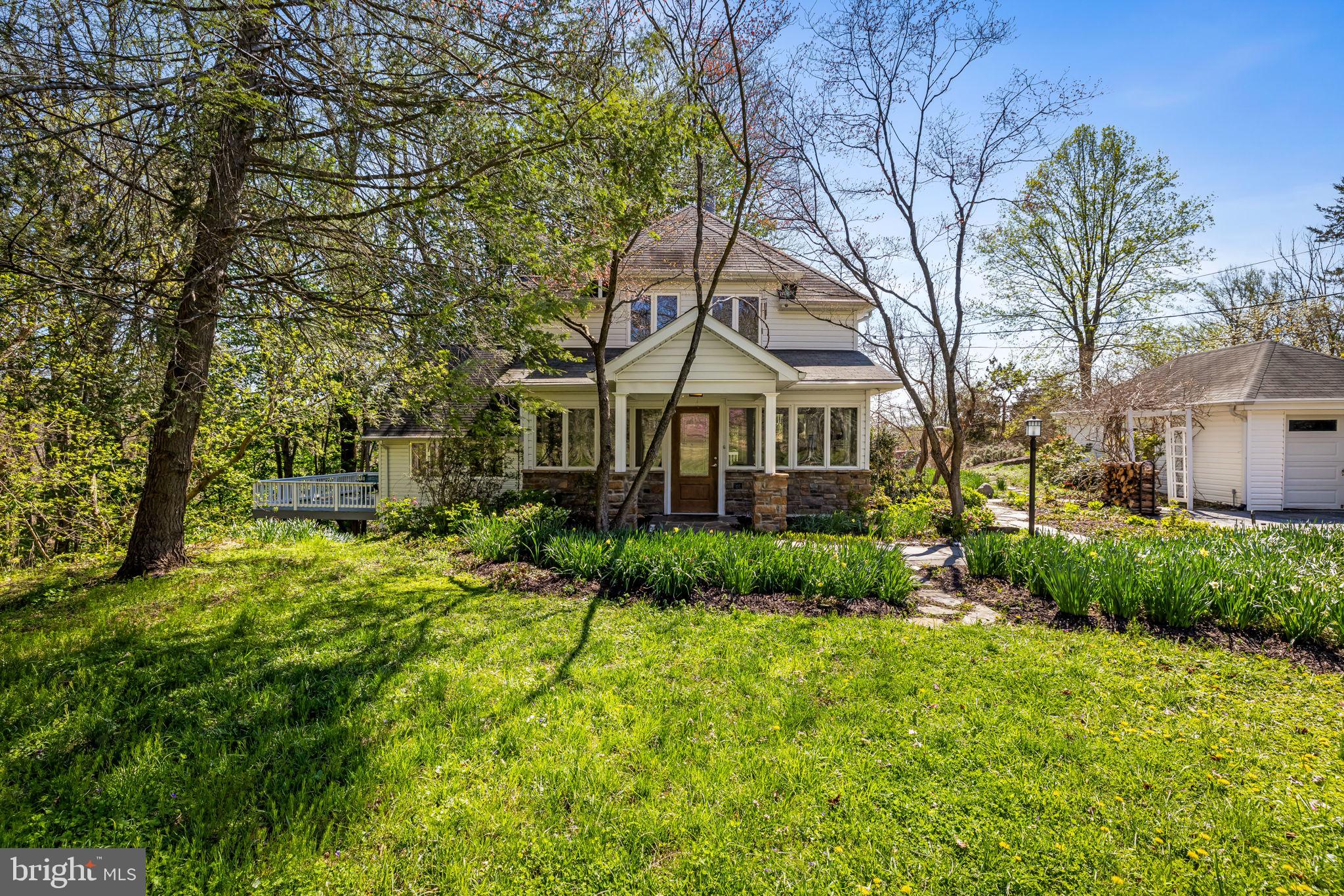 PRICE REDUCED!!  OPEN SUN 5/24  1:00-3:00 Your own private paradise on 16 acres, completely surrounded by nature’s bounty.  Beautiful Craftsman country home with a strong contemporary flare. Enter through the sunroom and into the living room, where you can cozy up in front of the propane fireplace. The dining room offers views of the backyard and the door to the covered deck. The sunroom, living room, dining room, kitchen, and family room all flow together and make a wonderful place for guests to gather. The huge cook’s kitchen has plenty of counters and cabinet space and a six-burner gas stove. The kitchen overlooks the open family room, with cathedral ceiling, huge windows, deck, and wood-burning fireplace. The main level also has a bedroom and a powder room. In 1995 the family room was added and the kitchen and entire second floor were remodeled, winning an award from Maryland Remodeling Association. Upstairs are three more bedrooms and two full baths, including the primary bedroom with a dramatic cathedral ceiling, hardwood floor, walk-in closet, and in-suite bathroom with laundry. In this storybook home filled with windows, everywhere you turn in any room you can see trees, meadows, flowers, deer, foxes, wild turkeys, and more. The grounds of this magnificent private oasis include 11 acres of mature forest, a year-round spring-fed creek, an orchard of fruit trees and blueberries, a fenced vegetable garden, kitchen herb garden, year-round flower garden, and a private hiking trail. This is a retreat where you can get away from it all, but it is still conveniently located seconds from Patapsco State Park, 10 minutes from Ellicott City, 30 minutes from Baltimore, and 18 minutes to a Marc train park-and-ride. the roof is approximately 14 years old and is believed to be a 30 year architectural shingle roof