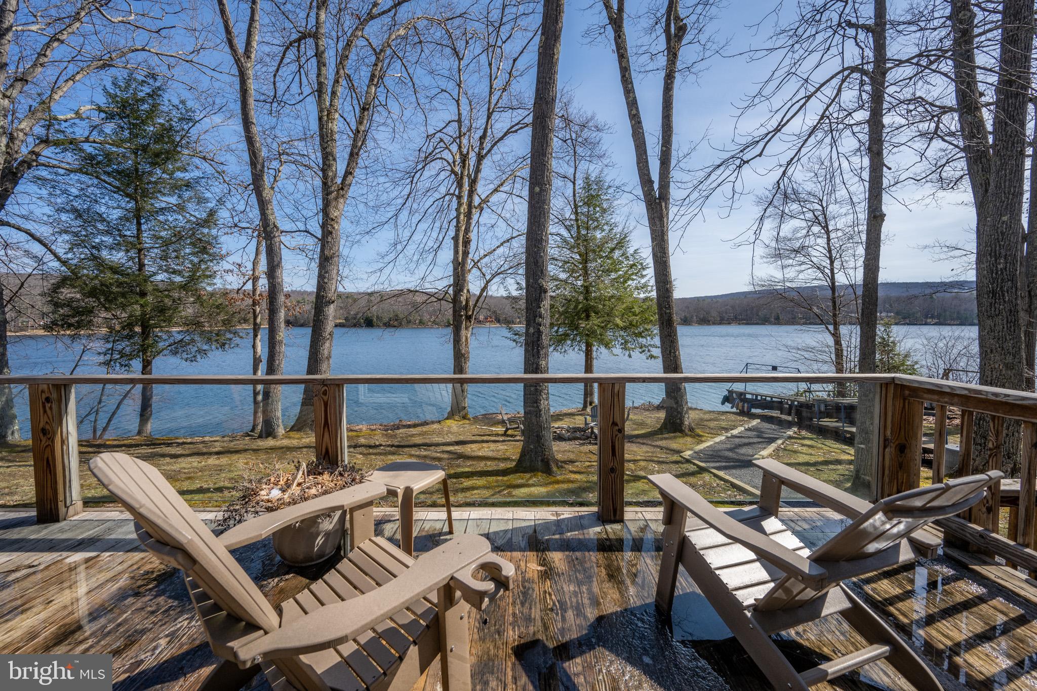 Prime Lake-frontage!  Enjoy the best in lake living at one of the best spots on the lake.   With 150' of spectacular frontage, the completely renovated  3 bedroom 2 bath one level cottage is the perfect place to escape the stresses of every day life.   Wake up to amazing sunrises on the ground level deck with over 180 degrees of breathtaking lake and mountain views.  The property qualifies for a Type A dock allowing for 2 power boats and personal water craft.   Located near the end of a low traffic county maintained road,  the level low maintenance wooded lot offers easy year round access regardless of the conditions.   Serviced by public sewage, the possibilities for future expansion are  many.   Don't miss your incredible lakefront opportunity.  Properties with these benefits are a rare find.