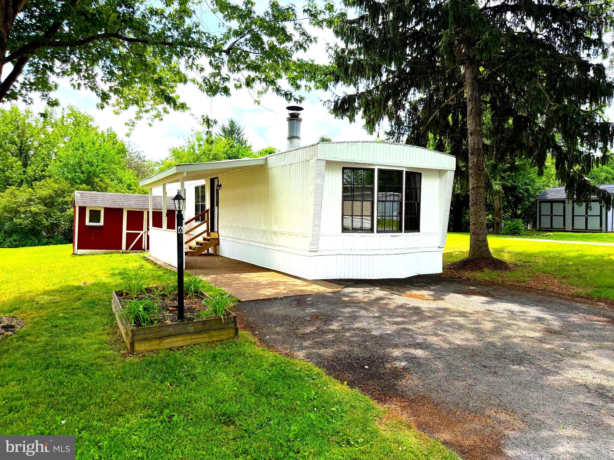 Remodeled Mobile Home in Country Manor West Community. Features: Open Kitchen with New Appliances, Separate Family Room with a Wood Burning Brick Fireplace and a large Living Room. New Laminate Wood Flooring, Carpet & Freshly Painted throughout. 2 Bedrooms and 1 Full Bath. Rear Shed and Off-Street Parking for 2 Cars. Park approval is required. Lot rent is $704.40 / monthly, which includes water / sewer / trash. The Mobile Home Park has a Community Pool with Club House and a playground with basketball courts.