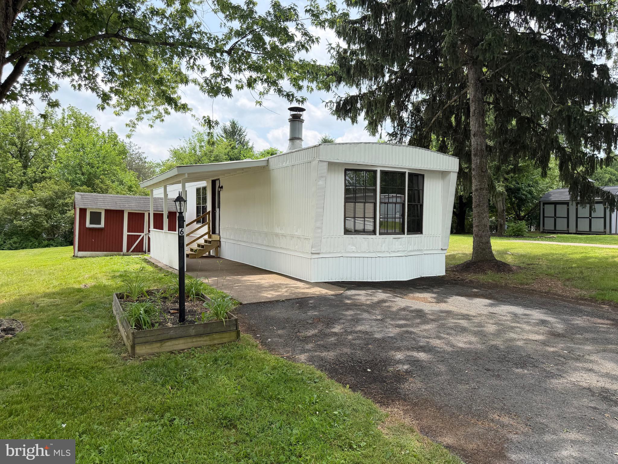 Remodeled Mobile Home in Country Manor West Community. Features: Open Kitchen, Separate Living Room with a Wood Burning Brick Fireplace, 2 Bedrooms and 1 Full Bath. Rear Shed and Off-Street Parking for 2 Cars. Park approval is required. Lot rent is $704.40 / monthly, which includes water / sewer / trash. Park has a playground and the pool is scheduled to be re-opened this summer.